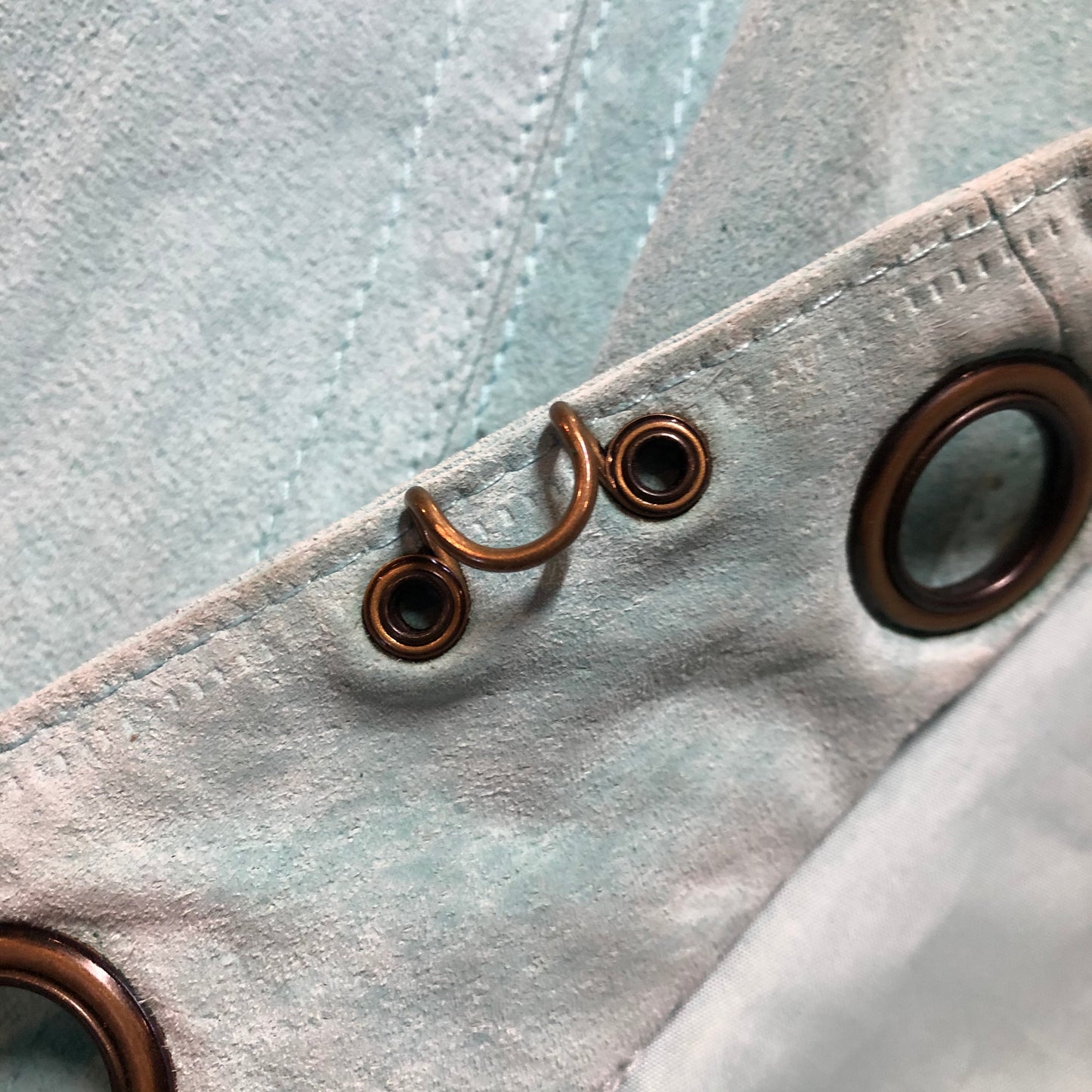 Kingspier Vintage - LAL “Live A LIttle” light teal suede jacket with hidden hook closures, brass grommets running down the front, two zip slash pockets and a small belt at the back. Size large.