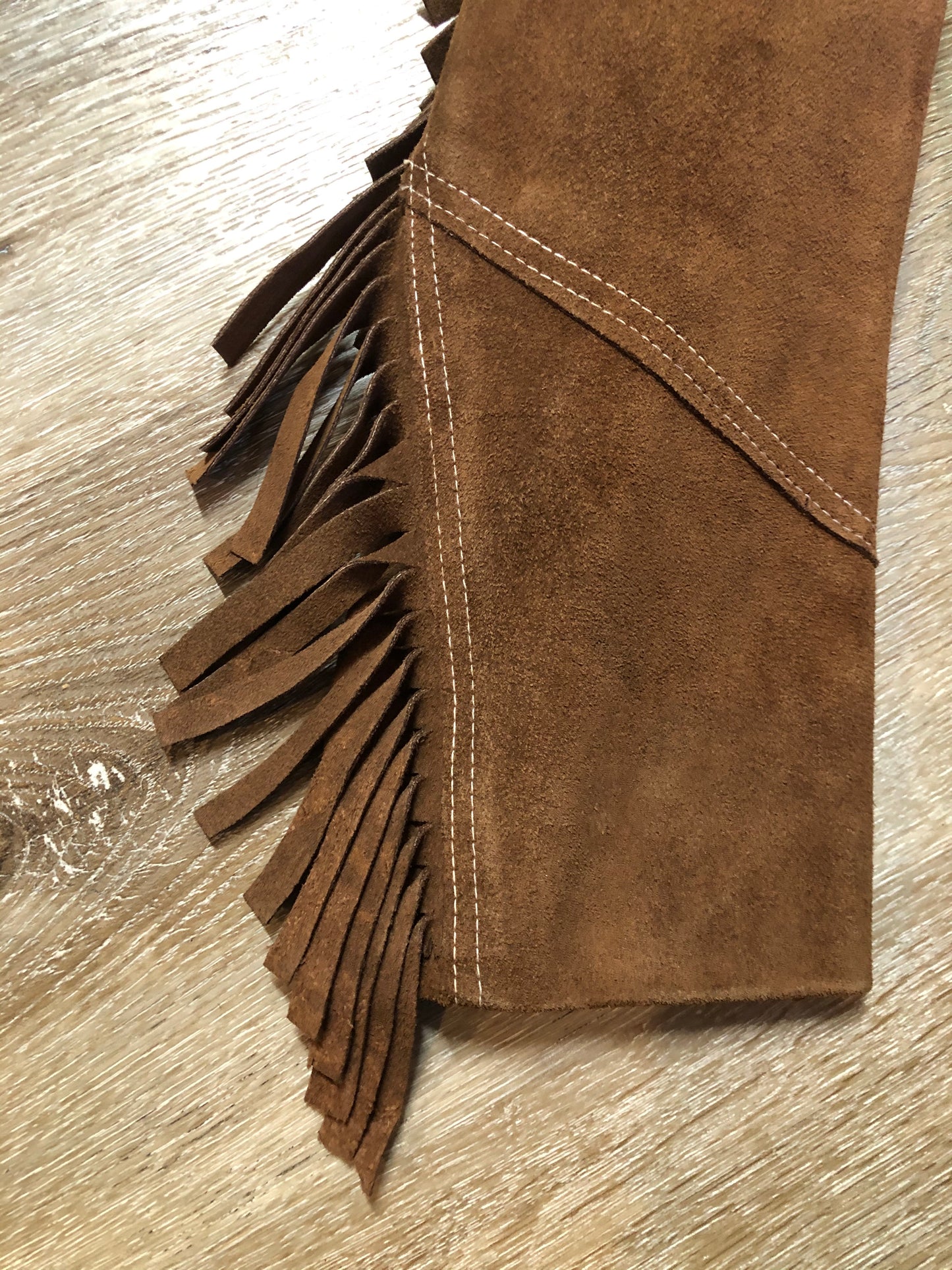 Kingspier Vintage - Jonathan Legault brown suede western style jacket with fringe details, belt in the back, button closures and slash pockets.