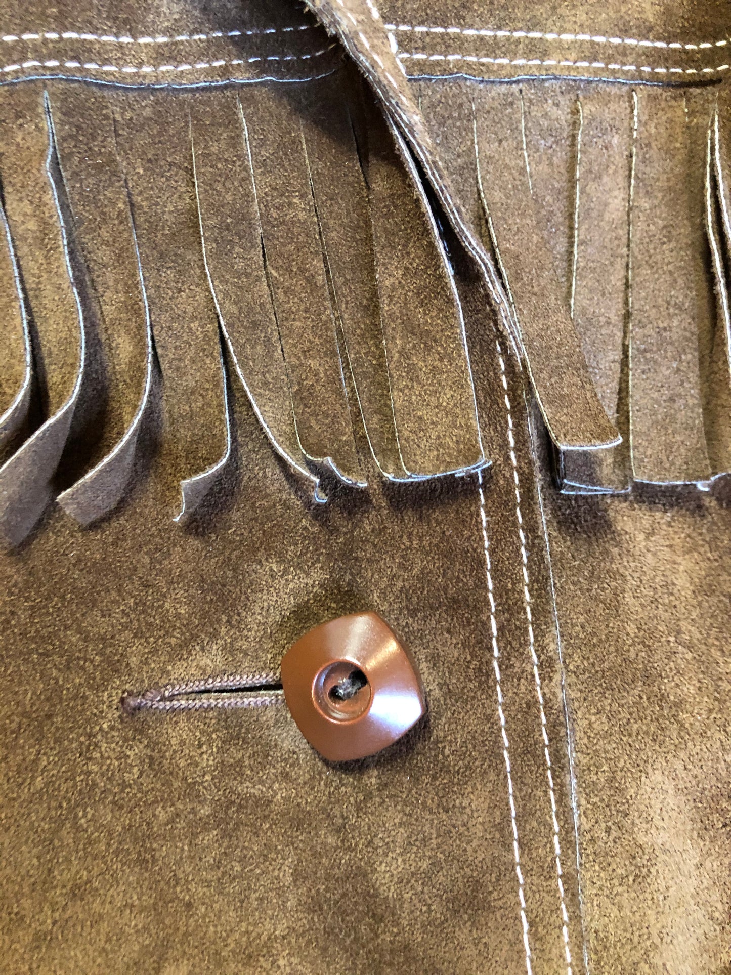 Kingspier Vintage - Jonathan Legault brown suede western style jacket with fringe details, belt in the back, button closures and slash pockets.
