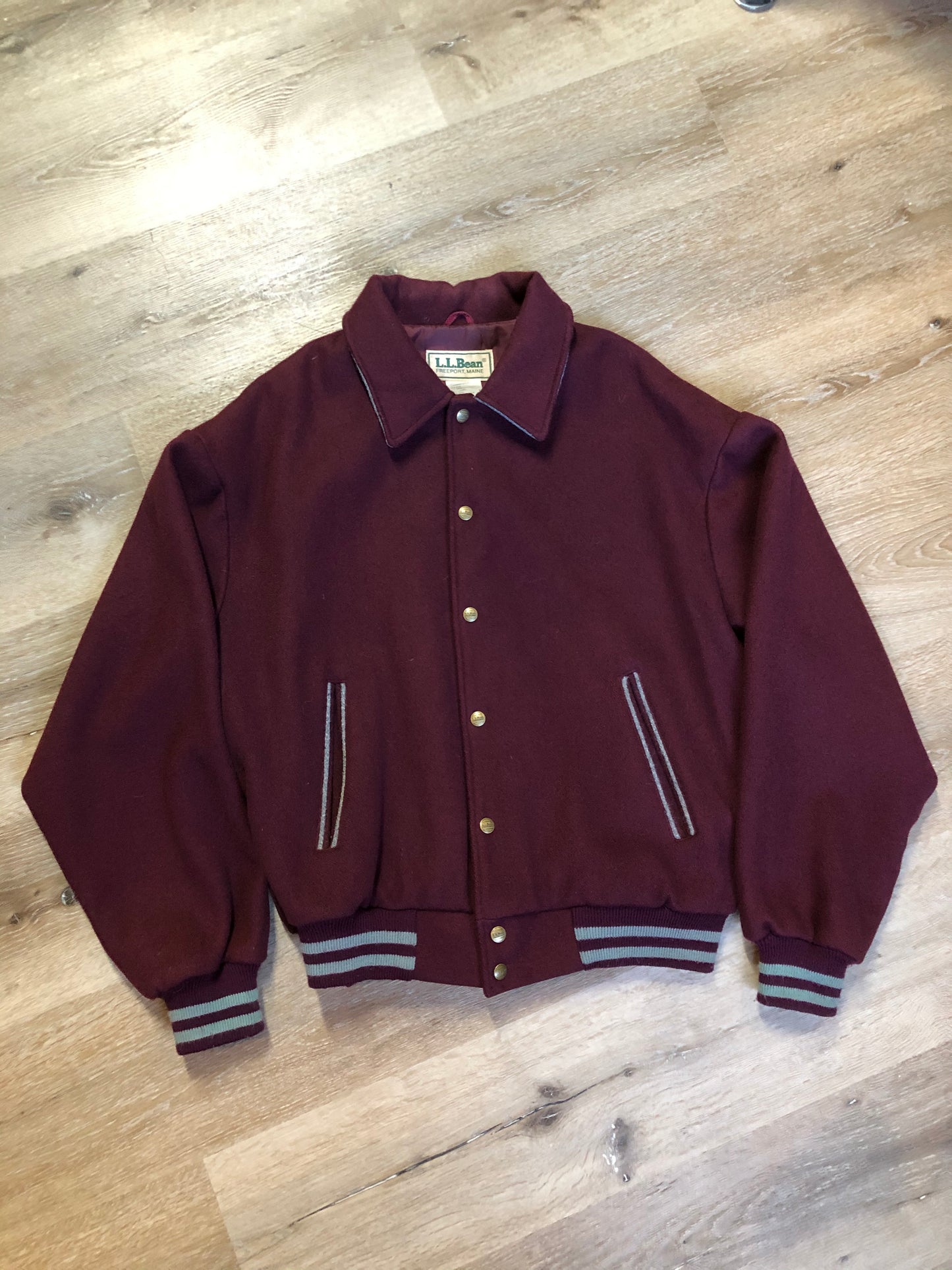 Kingspier Vintage - L.L.Bean bomber jacket in wine with snap closures with logo, knit trim and slash pockets. Size large.
