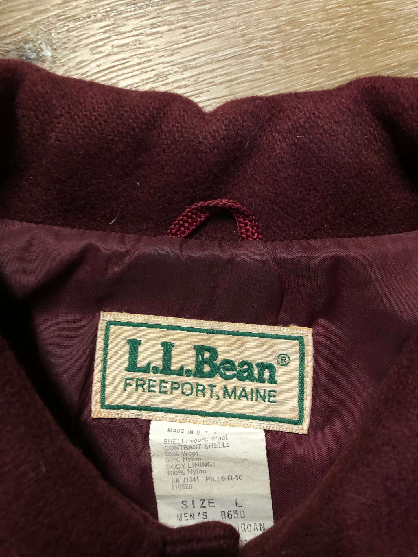 Kingspier Vintage - L.L.Bean bomber jacket in wine with snap closures with logo, knit trim and slash pockets. Size large.