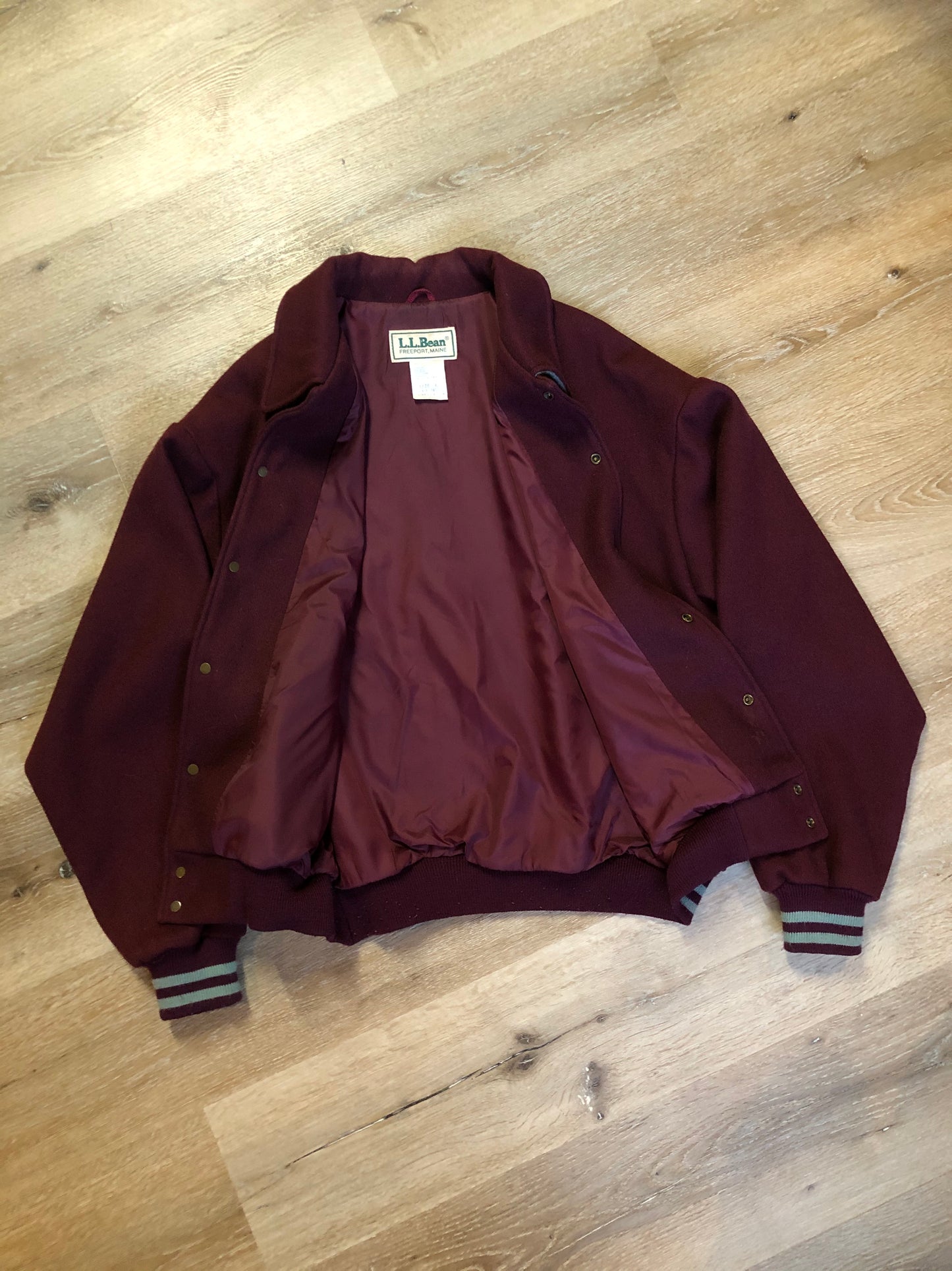 Kingspier Vintage - L.L.Bean bomber jacket in wine with snap closures with logo, knit trim and slash pockets. Size large.