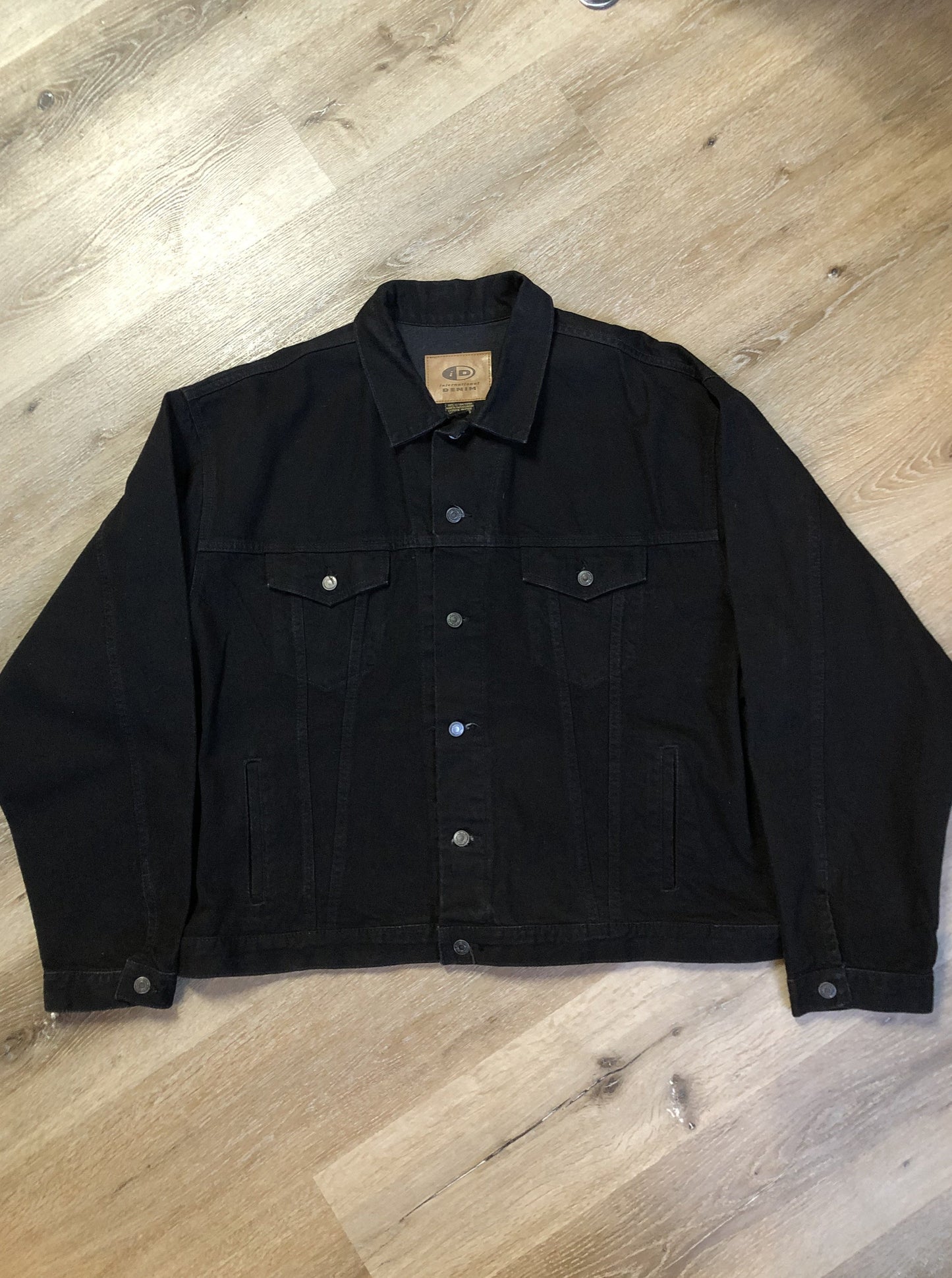 Kingspier Vintage - International Denim black denim jacket with button closures, two vertical pockets, two flap pockets and two inside pockets. Made in Canada. Size XXXL.