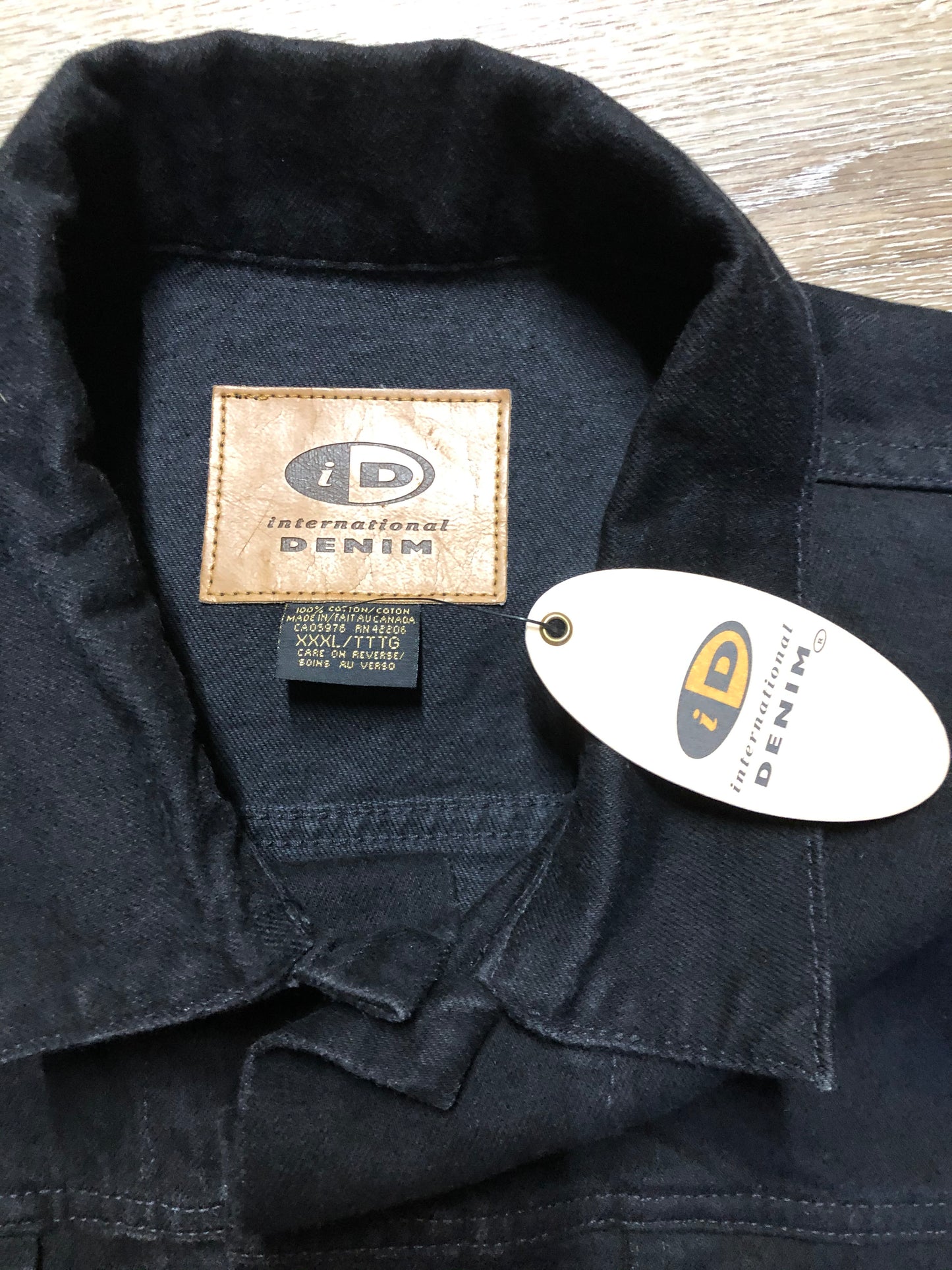 Kingspier Vintage - International Denim black denim jacket with button closures, two vertical pockets, two flap pockets and two inside pockets. Made in Canada. Size XXXL.