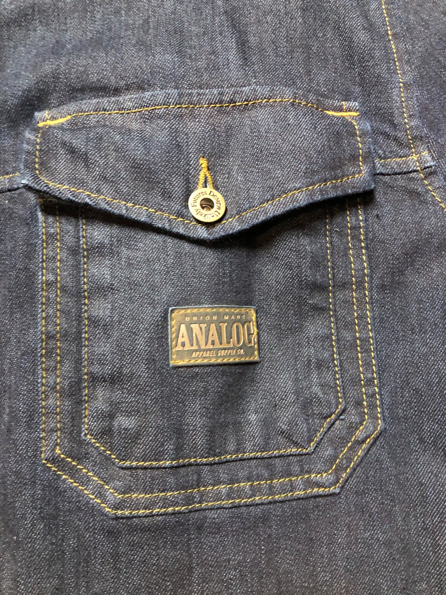 Kingspier Vintage - ATF (Analog Technical Fashion) denim jacket in a dark wash with button closures, two zip slash pockets, two flap pockets, an inside pocket and a plaid lining. Union made. Size XL.