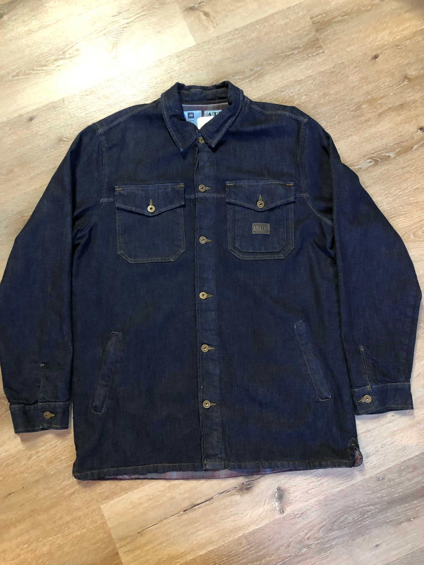 Kingspier Vintage - ATF (Analog Technical Fashion) denim jacket in a dark wash with button closures, two zip slash pockets, two flap pockets, an inside pocket and a plaid lining. Union made. Size XL.
