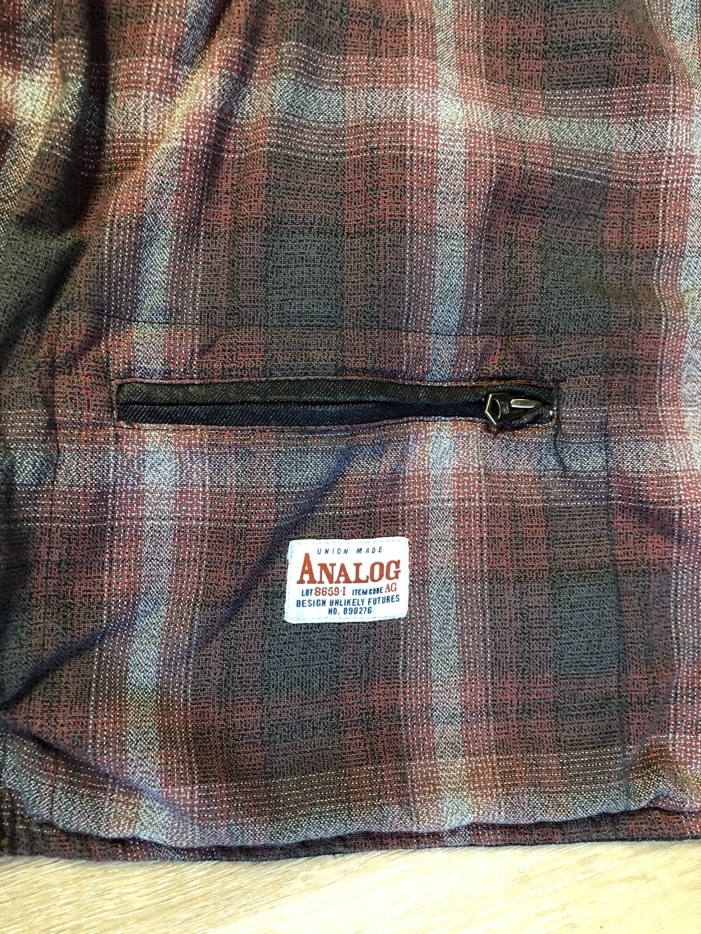 Kingspier Vintage - ATF (Analog Technical Fashion) denim jacket in a dark wash with button closures, two zip slash pockets, two flap pockets, an inside pocket and a plaid lining. Union made. Size XL.