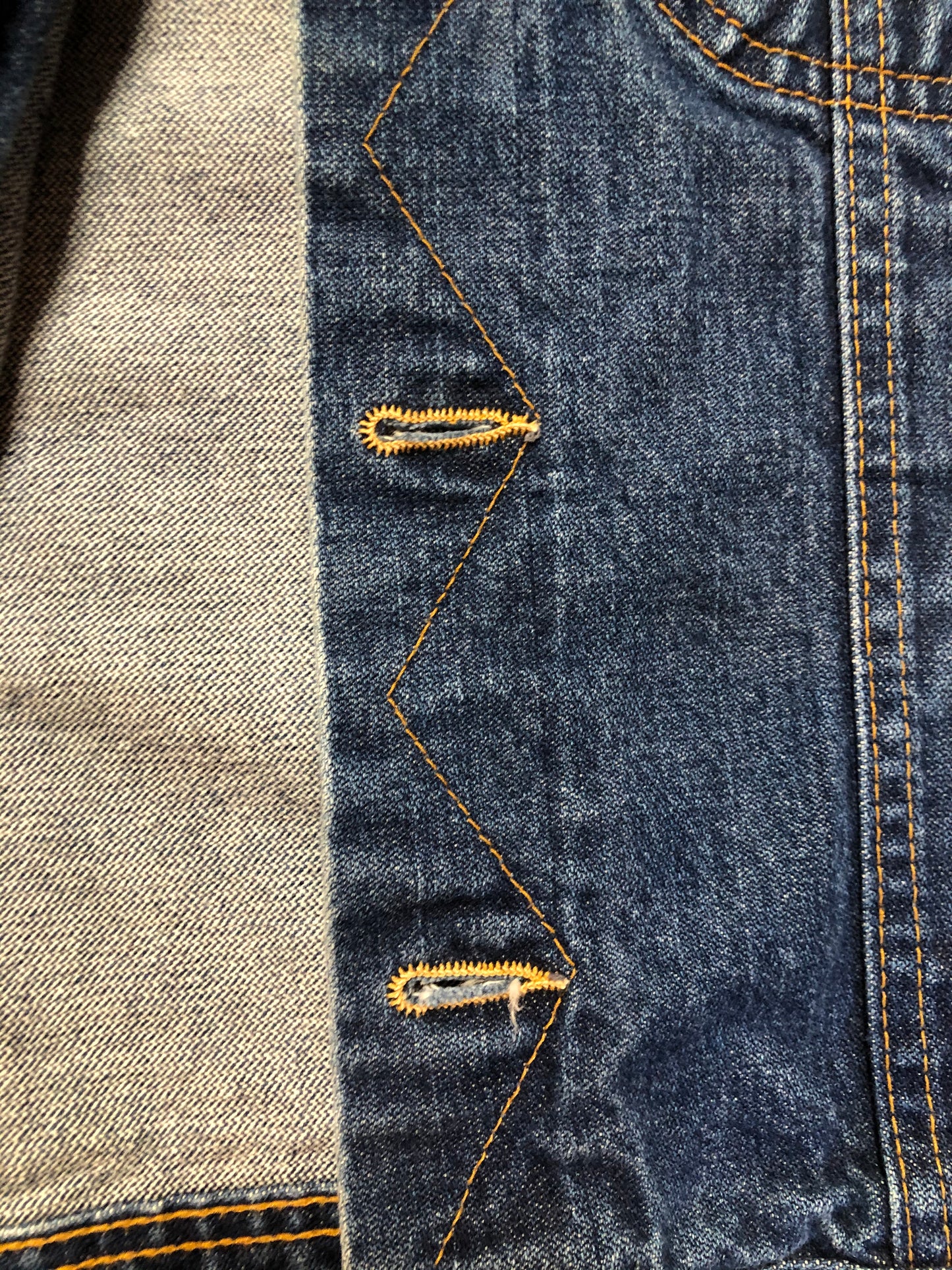 Kingspier Vintage - US Top denim jacket in a medium wash with button closures, two flap pockets on the chest, gold stitching with a unique stitch design down the center front.