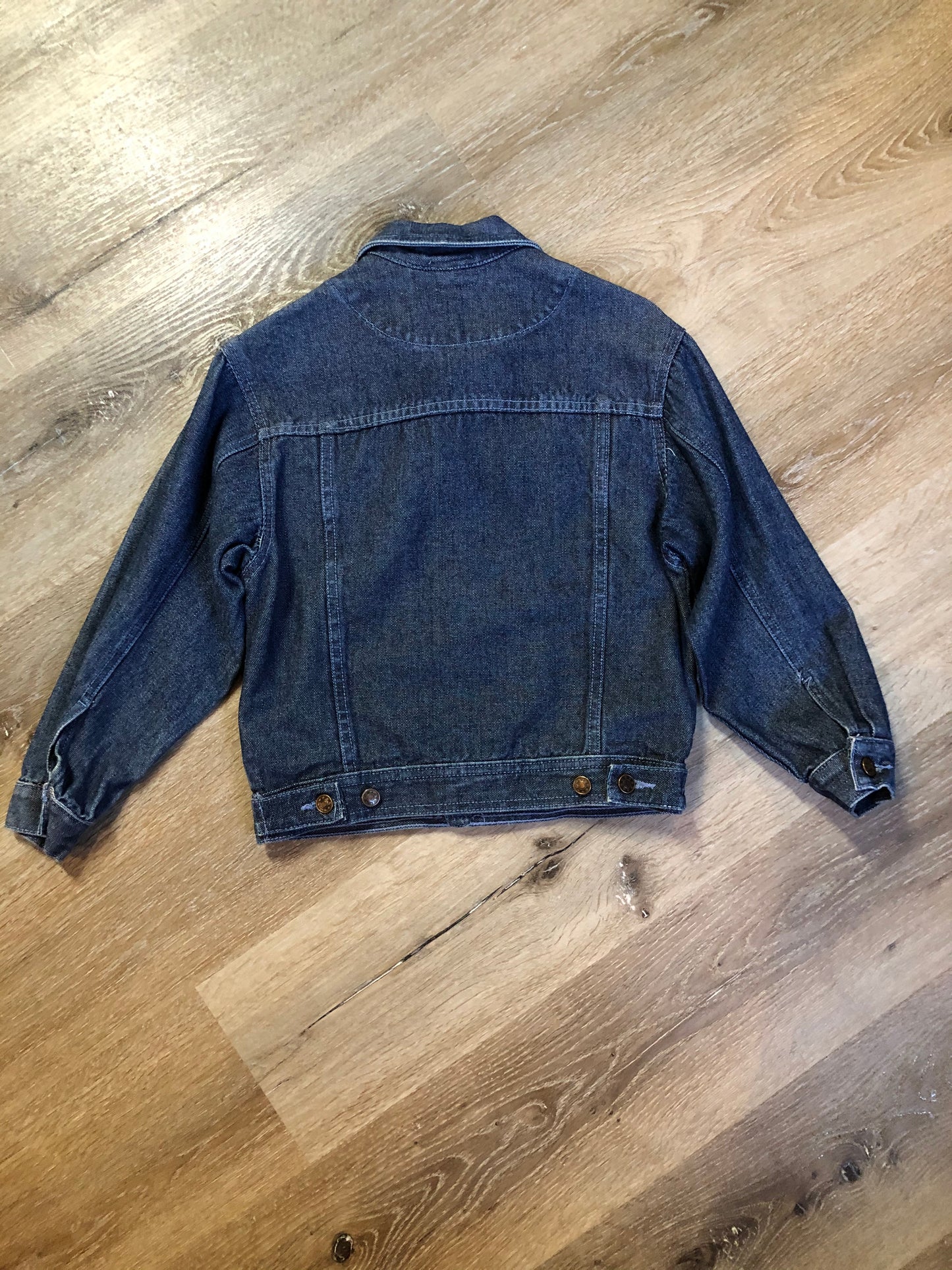 Kingspier Vintage - Guess ‘Georges Marciano’ denim jacket in a medium wash. This jacket features lavender stitching, button closures, two vertical pockets, two flap pockets on the chest and inside pockets. Made in the USA. Size small (fits very small).