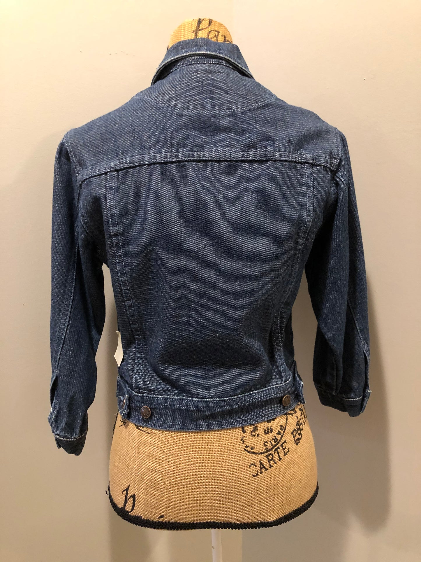 Kingspier Vintage - Guess ‘Georges Marciano’ denim jacket in a medium wash. This jacket features lavender stitching, button closures, two vertical pockets, two flap pockets on the chest and inside pockets. Made in the USA. Size small (fits very small).