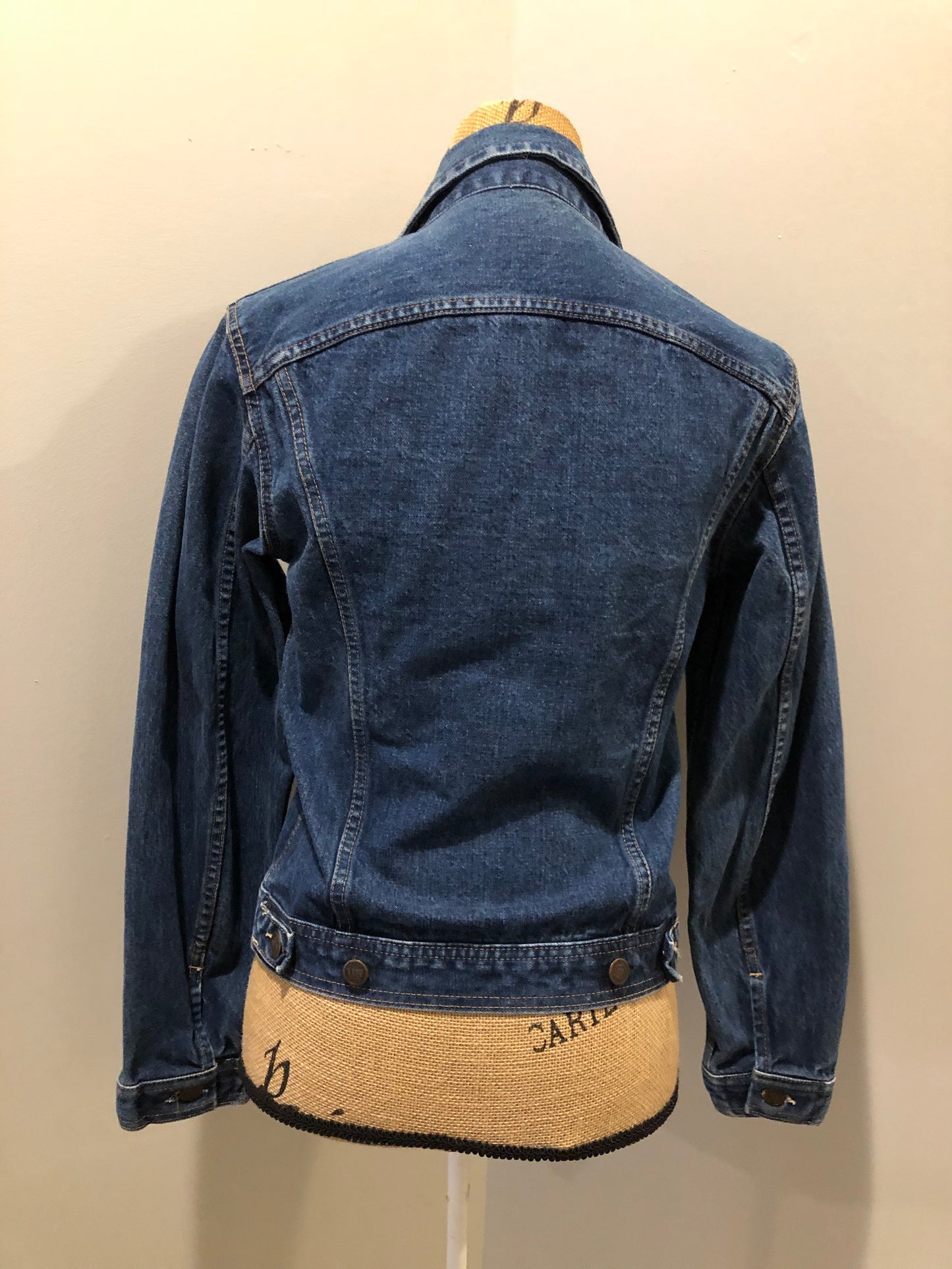 Kingspier Vintage - US Top denim jacket in a medium wash with button closures, two flap pockets on the chest, gold stitching with a unique stitch design down the center front.