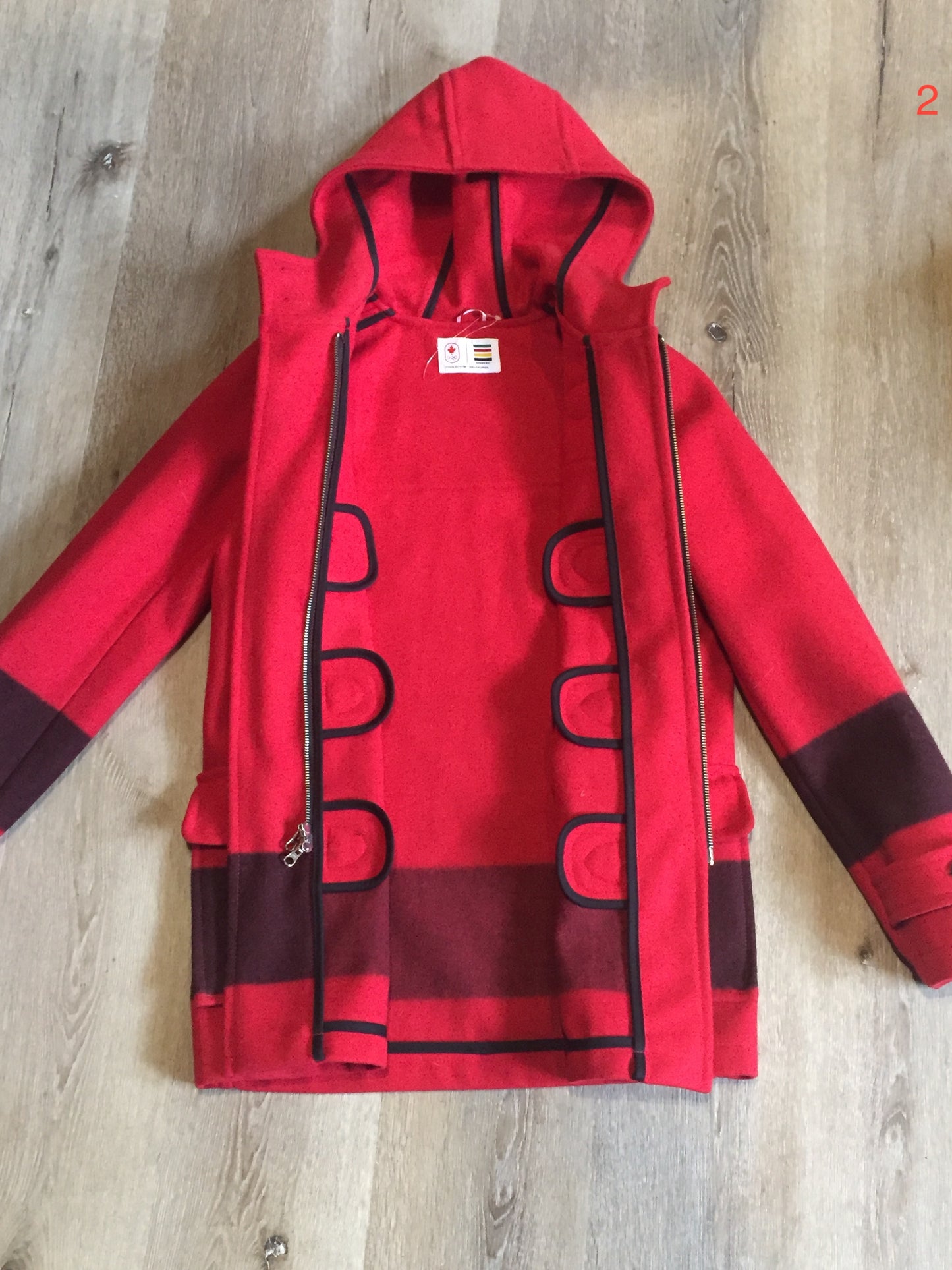 Kingspier Vintage - Hudson’s Bay Company official 2014 Olympics duffle coat in red with hood, toggles, zipper and flap pockets. Size is small.