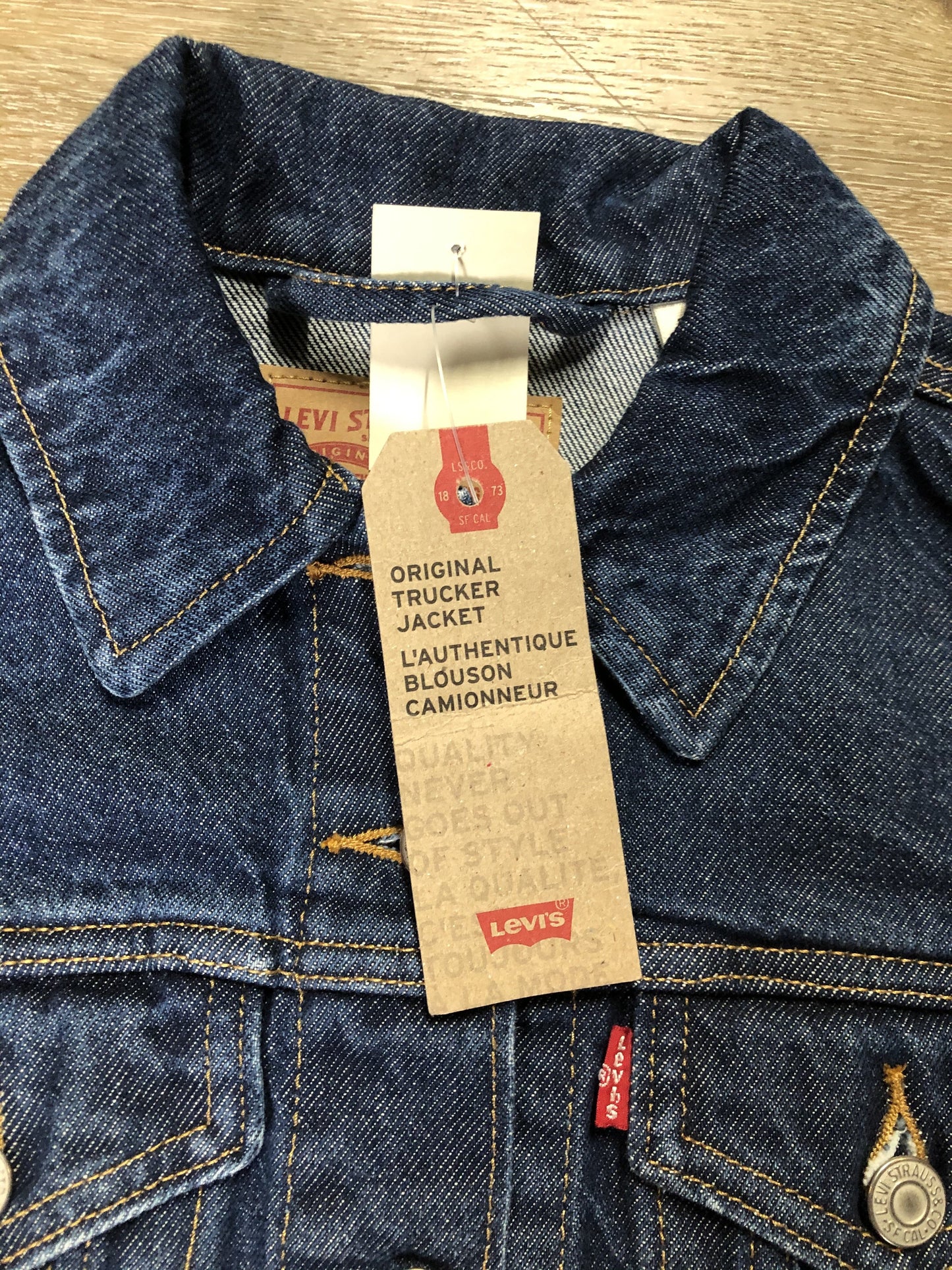 Kingspier Vintage - Levi’s Original Trucker Jacket in a medium wash denim with Canada leaf patch on the left shoulder, button closures, two vertical pockets and two flap pockets on the chest. Size XS.