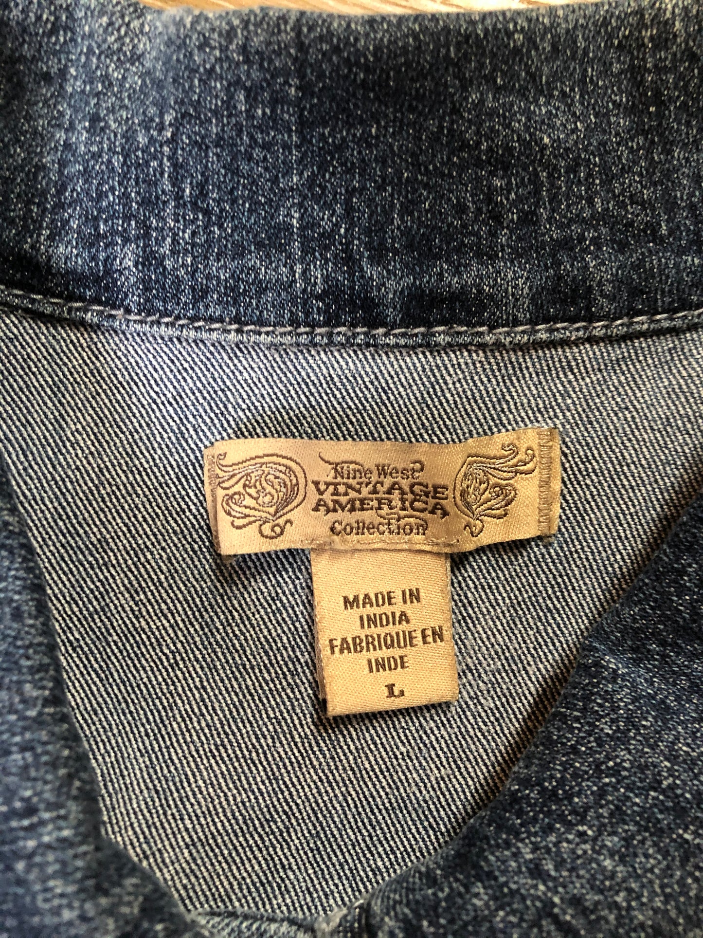 Kingspier Vintage - Nine West Vintage Collection denim jacket in a medium wash with vintage look material piece in the back, button clusters, two vertical pockets and two flap pockets on the chest. Size large.
