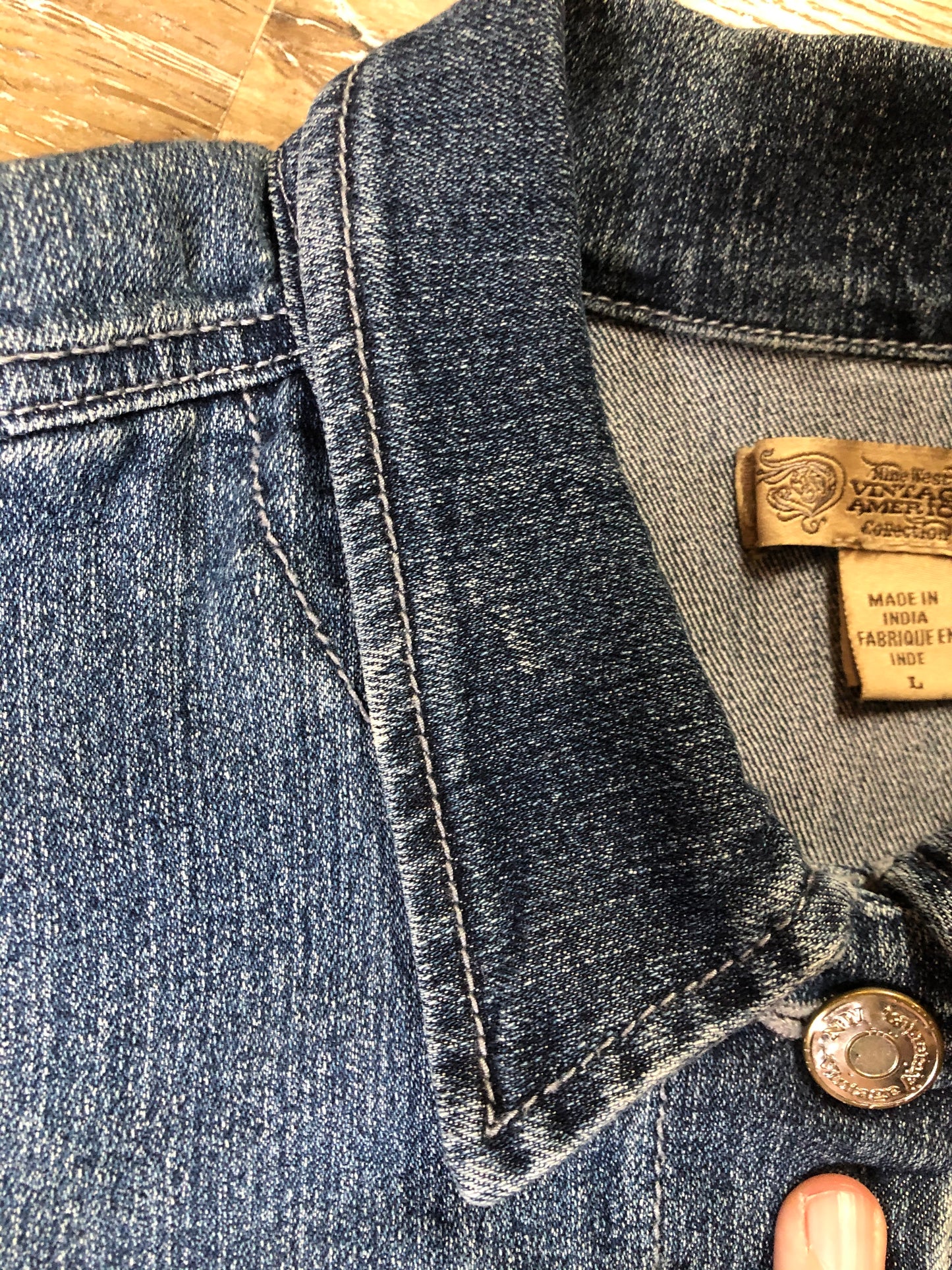 Kingspier Vintage - Nine West Vintage Collection denim jacket in a medium wash with vintage look material piece in the back, button clusters, two vertical pockets and two flap pockets on the chest. Size large.