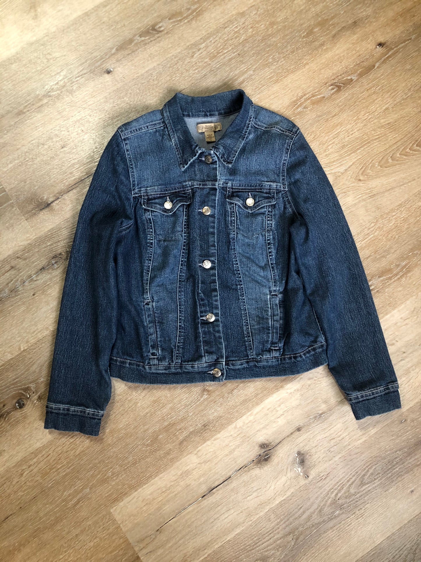 Kingspier Vintage - Nine West Vintage Collection denim jacket in a medium wash with vintage look material piece in the back, button clusters, two vertical pockets and two flap pockets on the chest. Size large.
