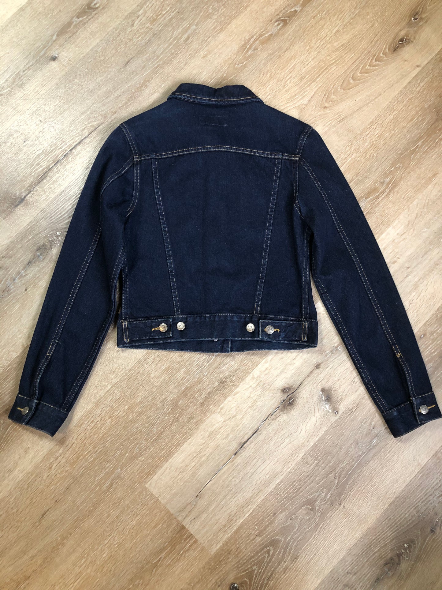 Kingspier Vintage - Angels denim jacket in a dark wash with button closures and two flap pockets. Size small.