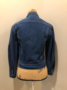 Kingspier Vintage - Lee denim jacket in a medium wash with unique stitching going down the Center front, button closures and two flap pockets on the chest. Union made in the USA. Size 8.