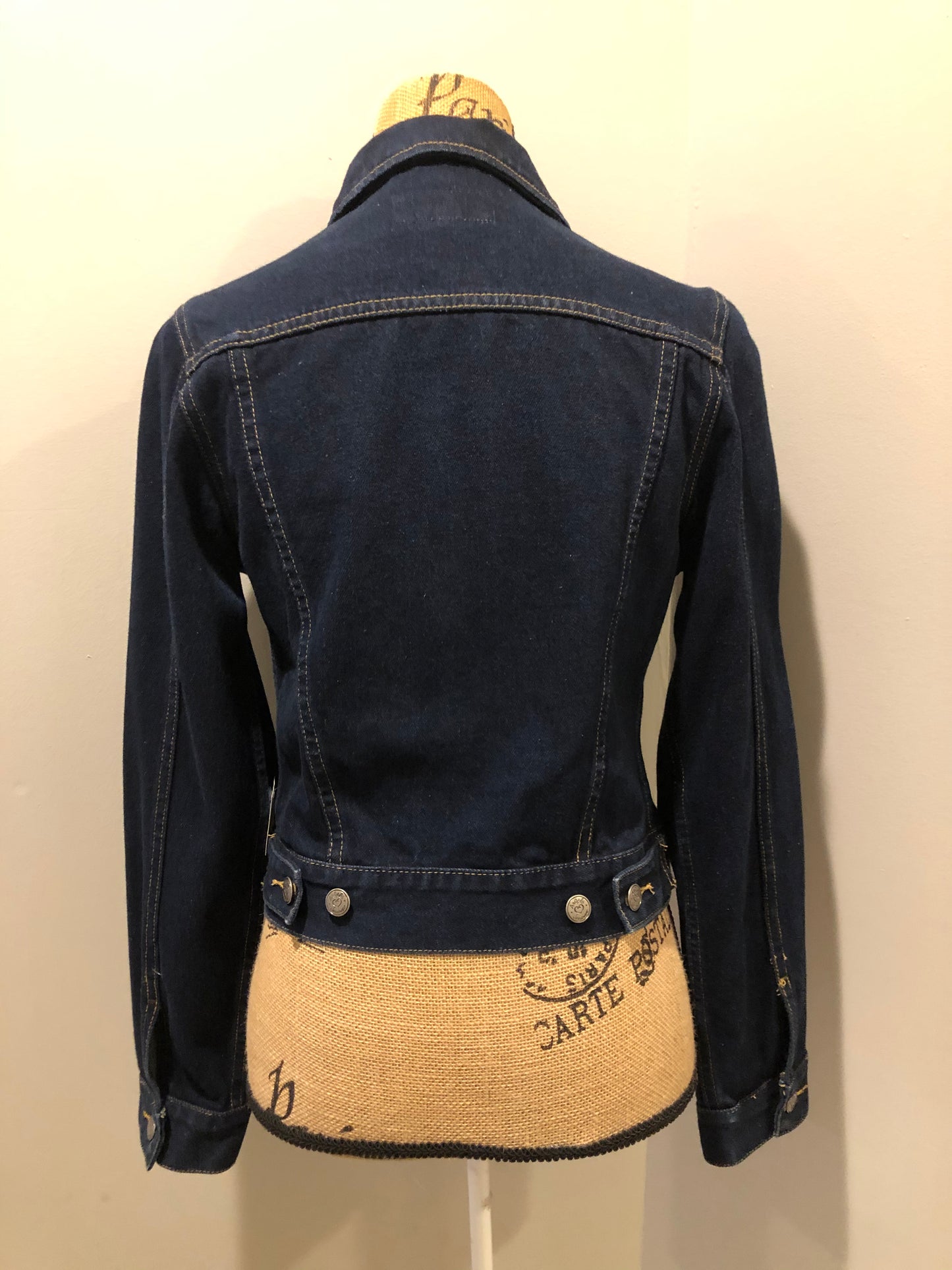 Kingspier Vintage - Angels denim jacket in a dark wash with button closures and two flap pockets. Size small.