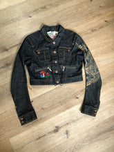 Load image into Gallery viewer, Kingspier Vintage - People for Peace cropped denim jacket in a dark wash with colourful embroidery all over, button closures, two zip pockets and two flap pockets on the chest. Size small.
