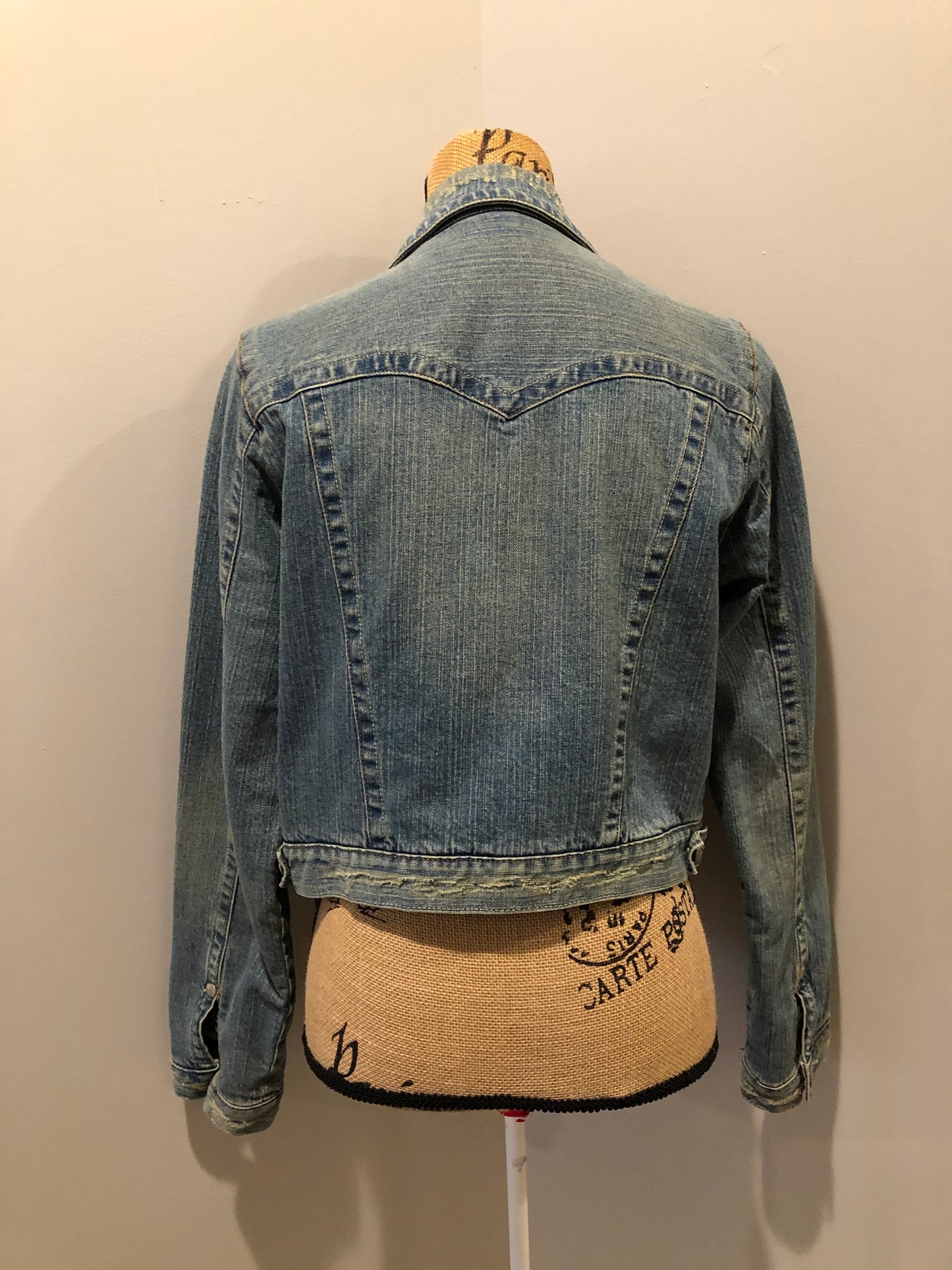 Kingspier Vintage - Younique denim jacket in a distressed light wash with colourful striped wool blend lining, button closures and two flap pockets. Size large, fits more like a medium.
