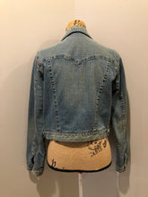 Load image into Gallery viewer, Kingspier Vintage - Younique denim jacket in a distressed light wash with colourful striped wool blend lining, button closures and two flap pockets. Size large, fits more like a medium. 
