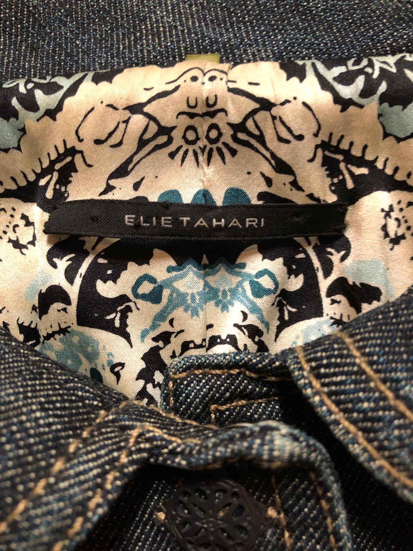 Kingspier Vintage - Elie Tahari denim jacket in a faded dark wash with beaded velvet collar, decorative snap closures, deep green velvet belt and a beautiful patterned silk lining. Size small.