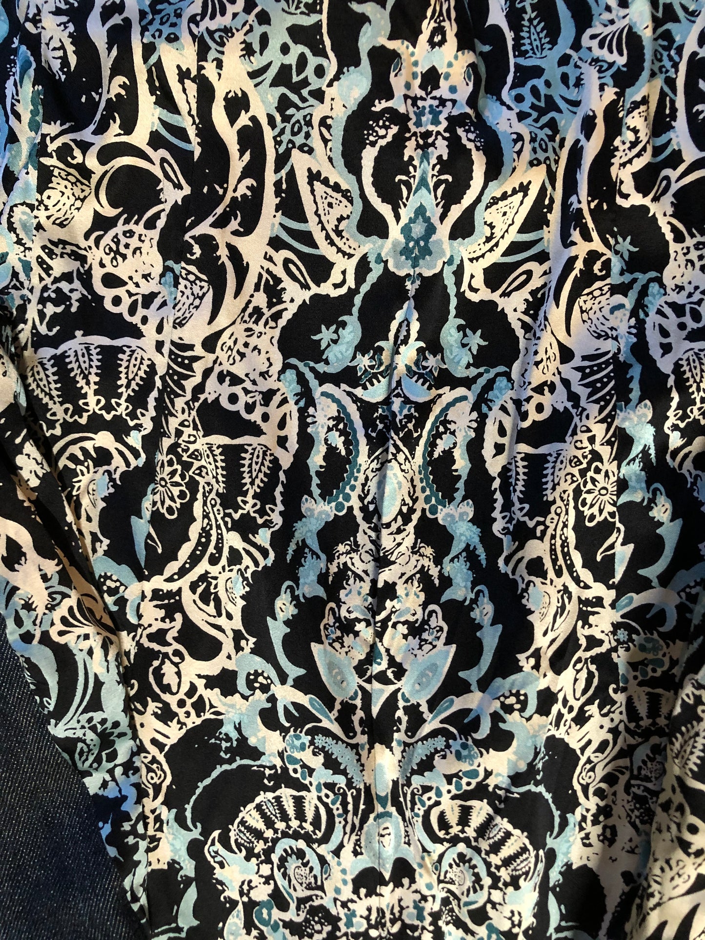 Kingspier Vintage - Elie Tahari denim jacket in a faded dark wash with beaded velvet collar, decorative snap closures, deep green velvet belt and a beautiful patterned silk lining. Size small.