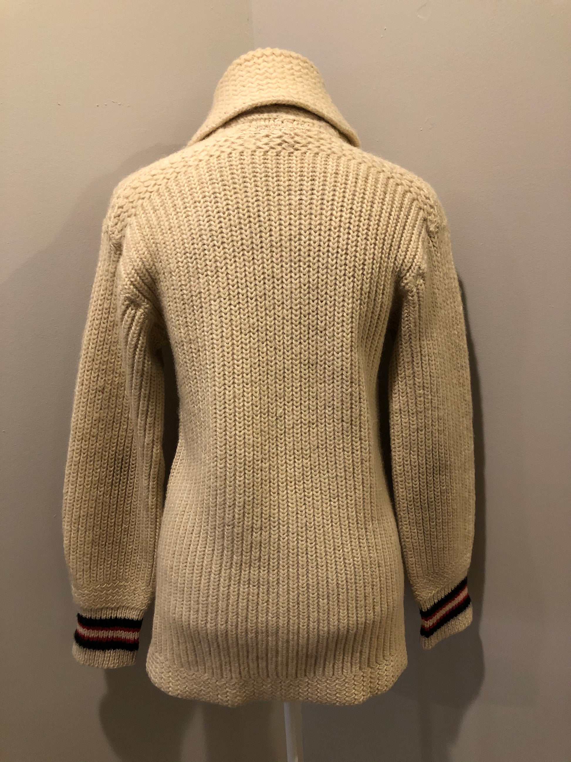 Kingspier Vintage - Curl-Rite by Rice-Knit Sportswear 1950’s curing sweater in cream with red and black strip details, shawl collar, button closures and pockets. 100% wool. Size medium. Made in Nova Scotia.