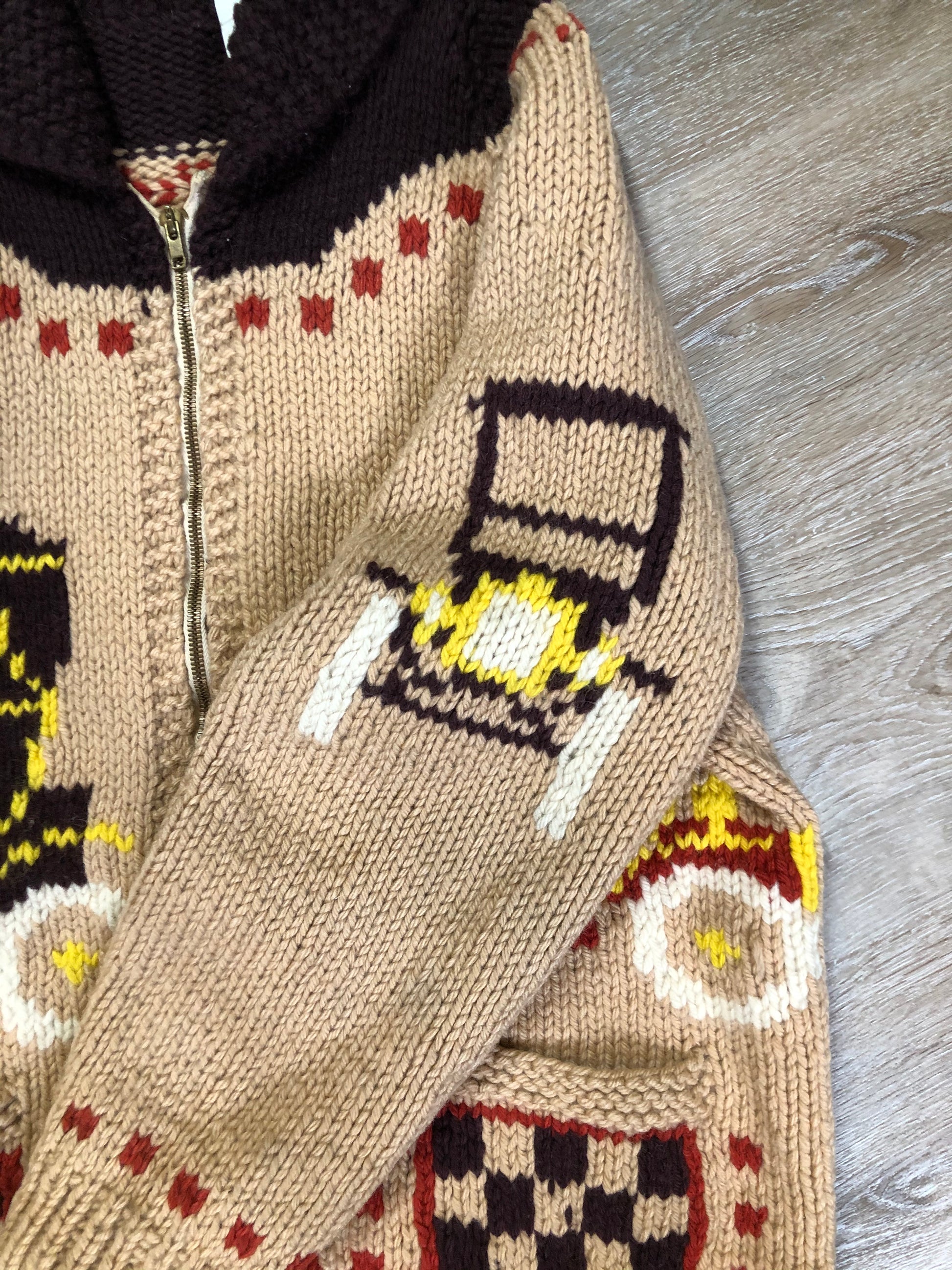 Kingspier Vintage - Mary Maxim hand knit wool zip cardigan in light brown with dark brown, red, yellow and cream with antique car design, raglan sleeves, zipper and pockets. Made in Nova Scotia.