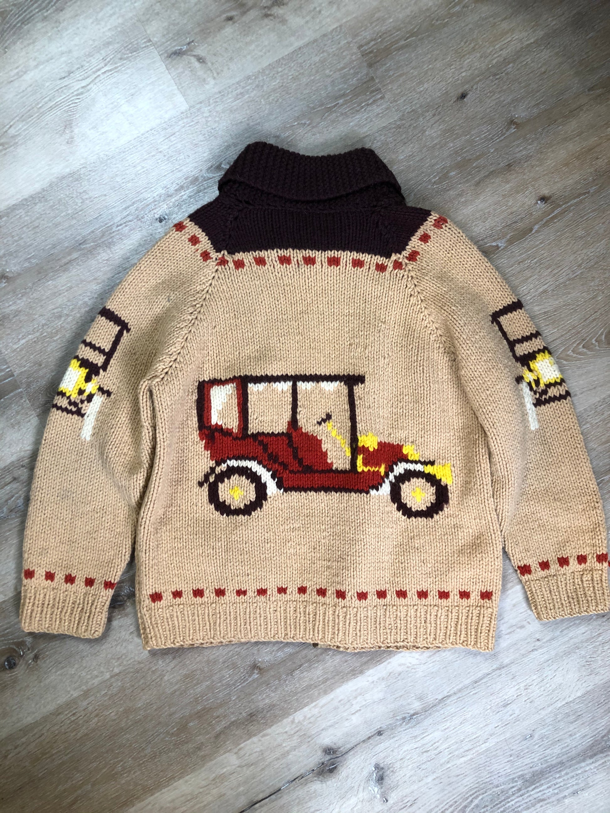 Kingspier Vintage - Mary Maxim hand knit wool zip cardigan in light brown with dark brown, red, yellow and cream with antique car design, raglan sleeves, zipper and pockets. Made in Nova Scotia.