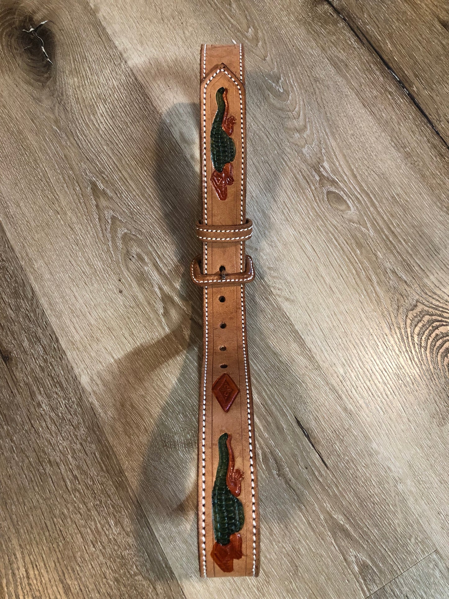 Kingspier Vintage -Vintage handtooled El Salvador brown full grain leather belt with crocodile motif and a leather wrapped buckle.