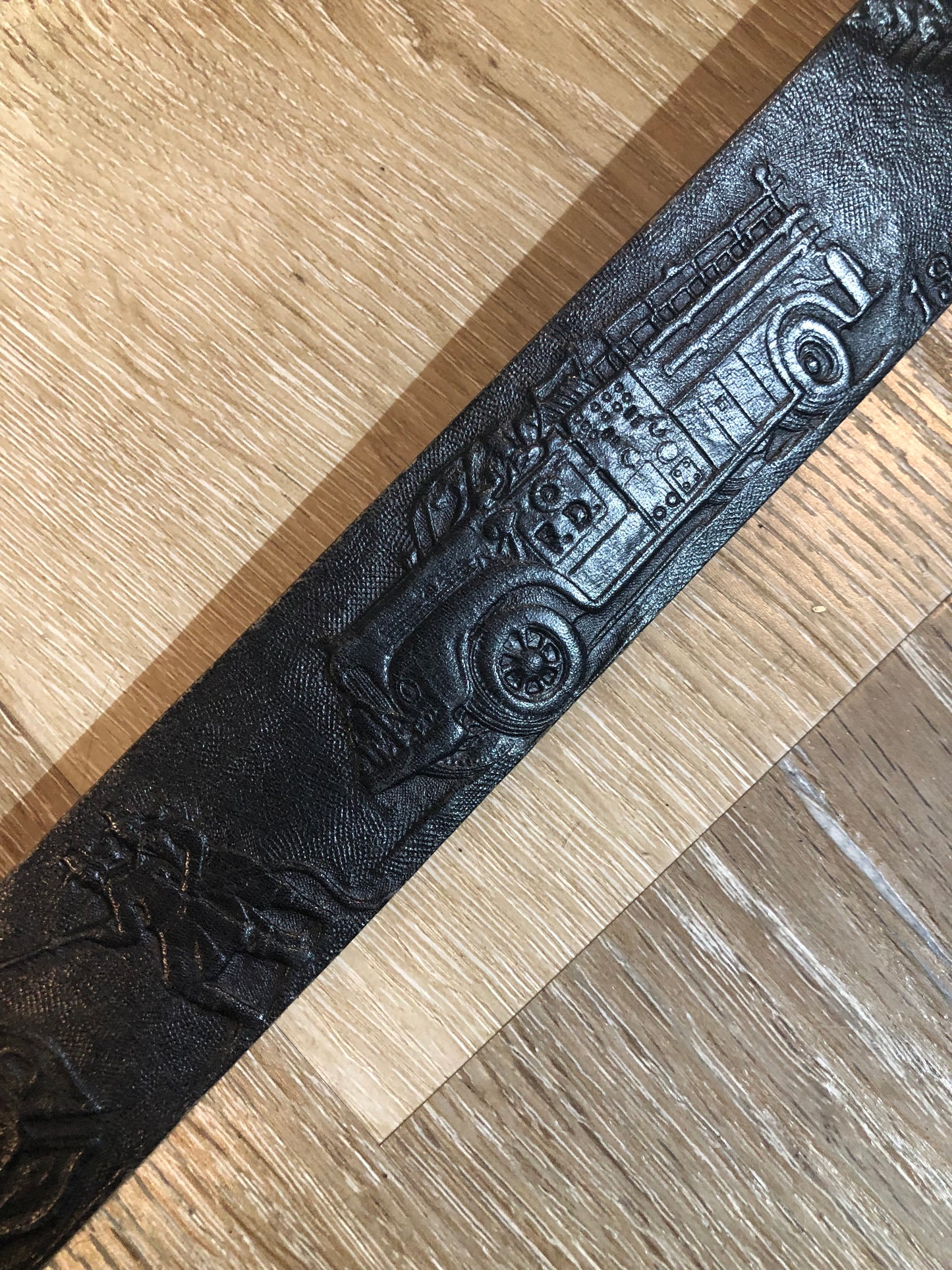 Kingspier Vintage - Vintage Noma Leather black full grain leather firefighter belt with brass buckle and embossed illustration of the evolution of the fire truck from 1922-1984. Made in Canada