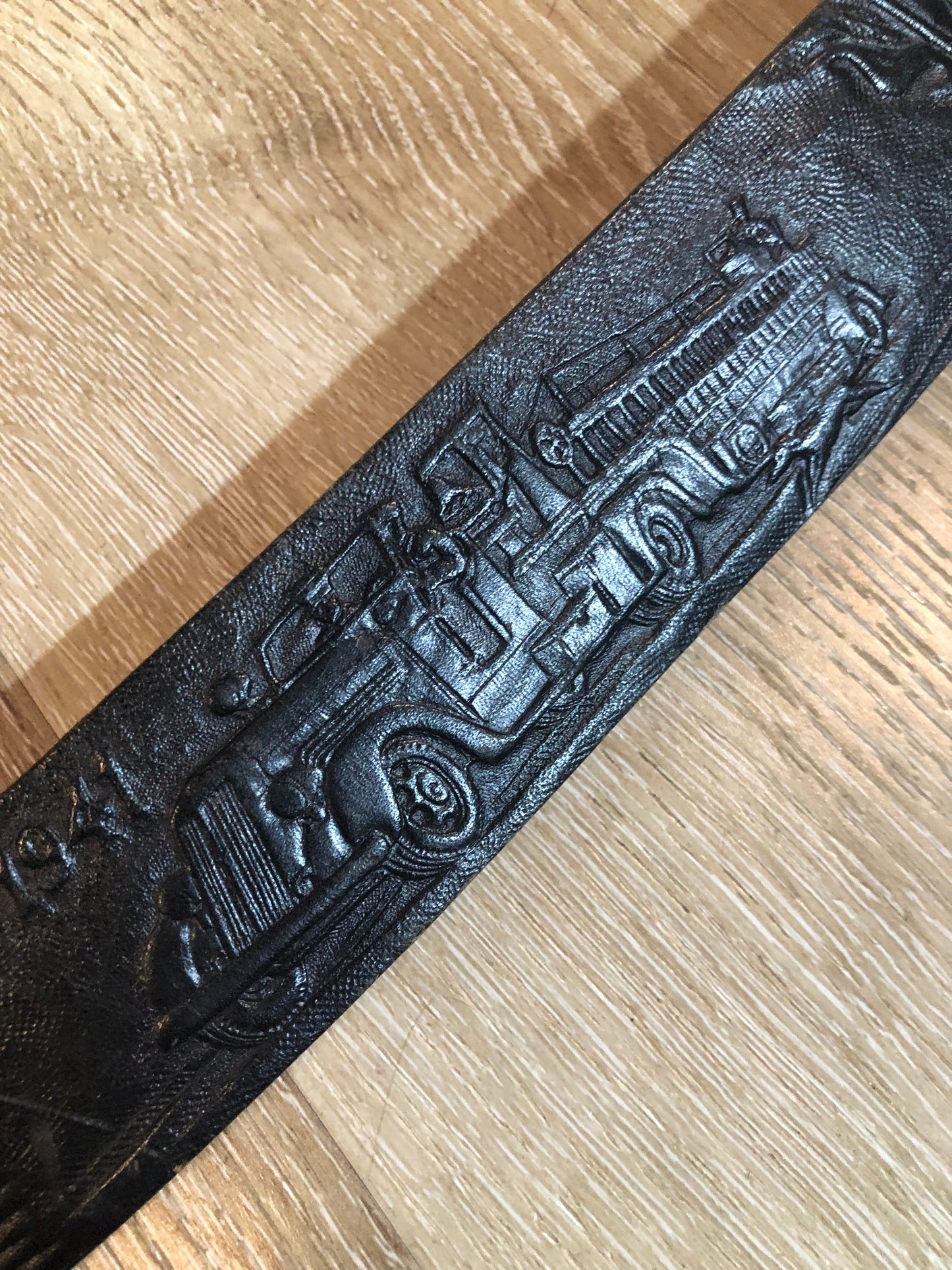 Kingspier Vintage - Vintage Noma Leather black full grain leather firefighter belt with brass buckle and embossed illustration of the evolution of the fire truck from 1922-1984. Made in Canada