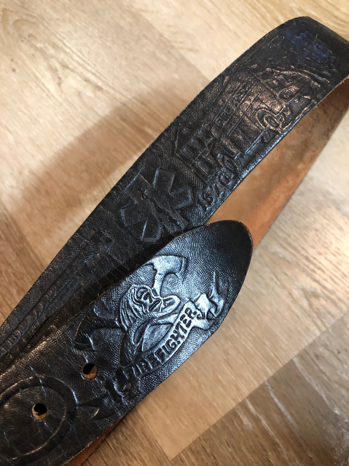 Kingspier Vintage - Vintage Noma Leather black full grain leather firefighter belt with brass buckle and embossed illustration of the evolution of the fire truck from 1922-1984. Made in Canada