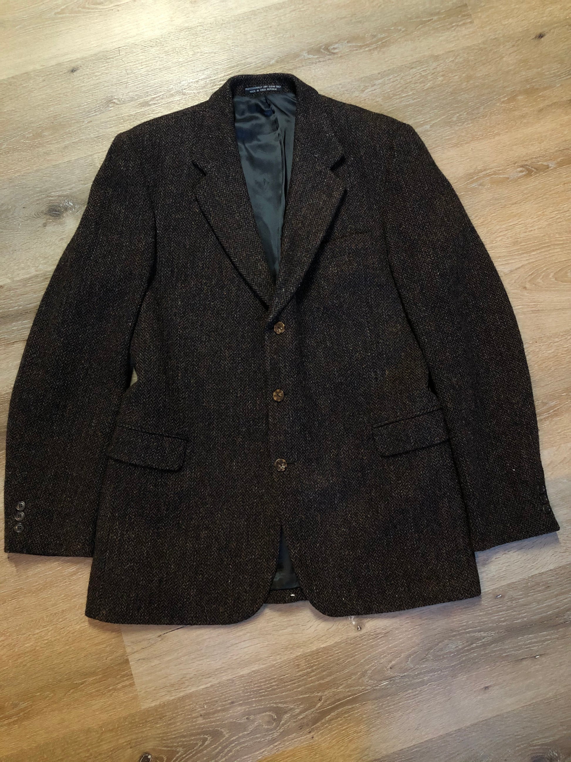 Kingspier Vintage - Harris Tweed brown and blue herringbone 100% wool jacket. This jacket is a three button, notch lapel with two flap pockets, a breast pocket and three inside pockets. Made in the Czech Republic.