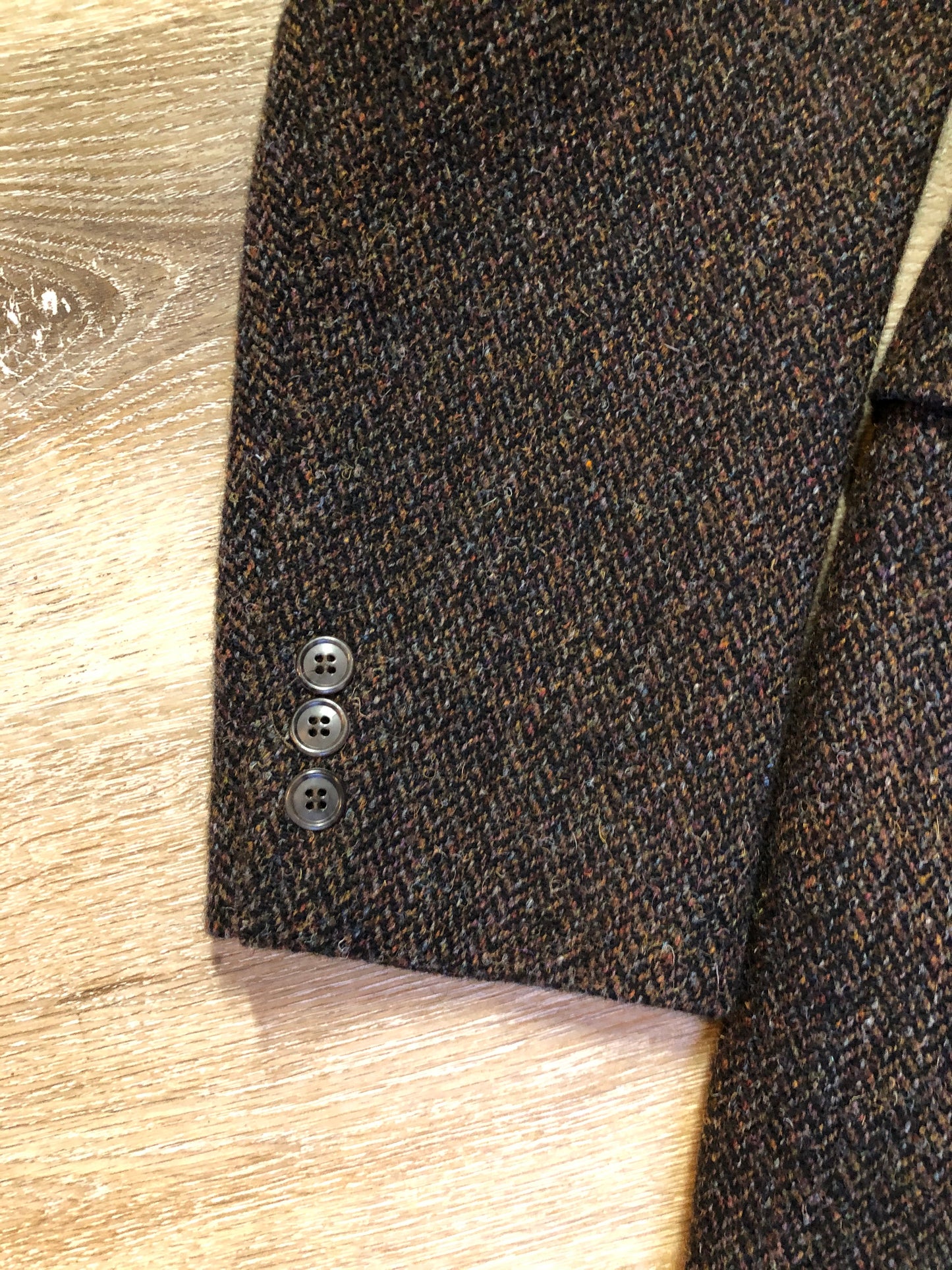 Kingspier Vintage - Harris Tweed brown and blue herringbone 100% wool jacket. This jacket is a three button, notch lapel with two flap pockets, a breast pocket and three inside pockets. Made in the Czech Republic.