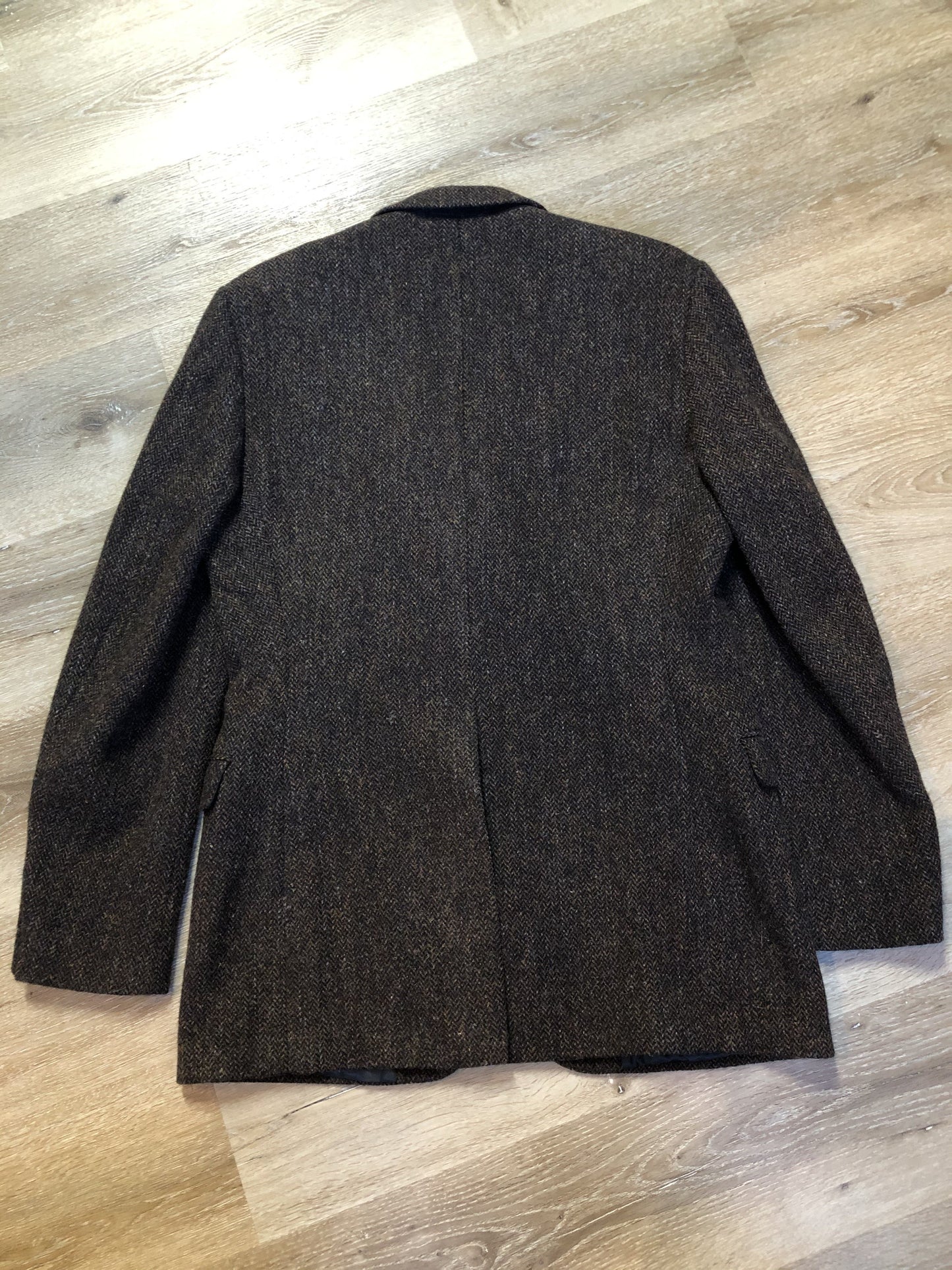 Kingspier Vintage - Harris Tweed brown and blue herringbone 100% wool jacket. This jacket is a three button, notch lapel with two flap pockets, a breast pocket and three inside pockets. Made in the Czech Republic.