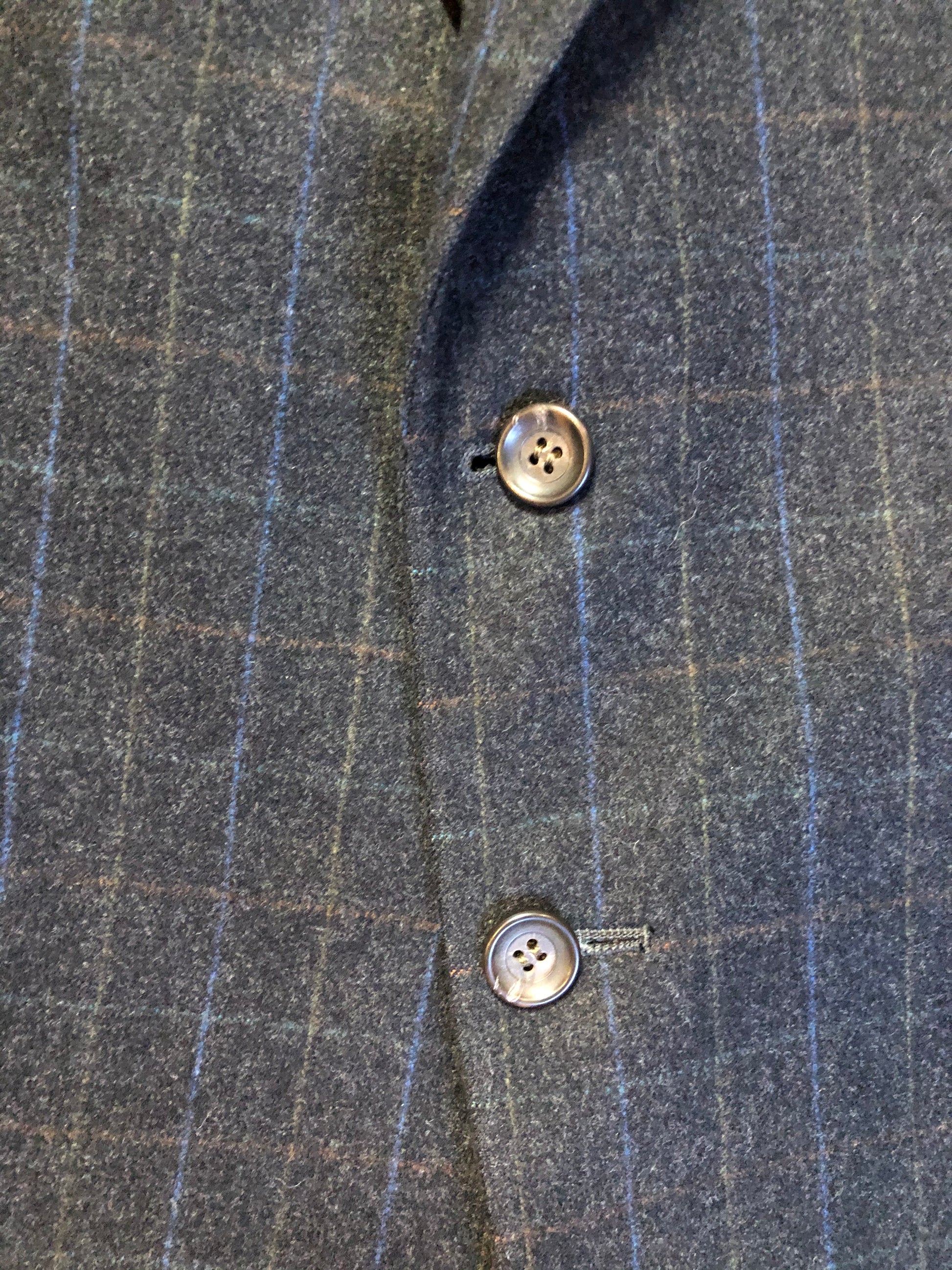 Kingspier Vintage - Chaps by Ralph Lauren slate grey with blue and red subtle stripe 100% wool jacket. This jacket is a two button, notch lapel with two flap pockets, a breast pocket and three inside pockets. Made in Canada.