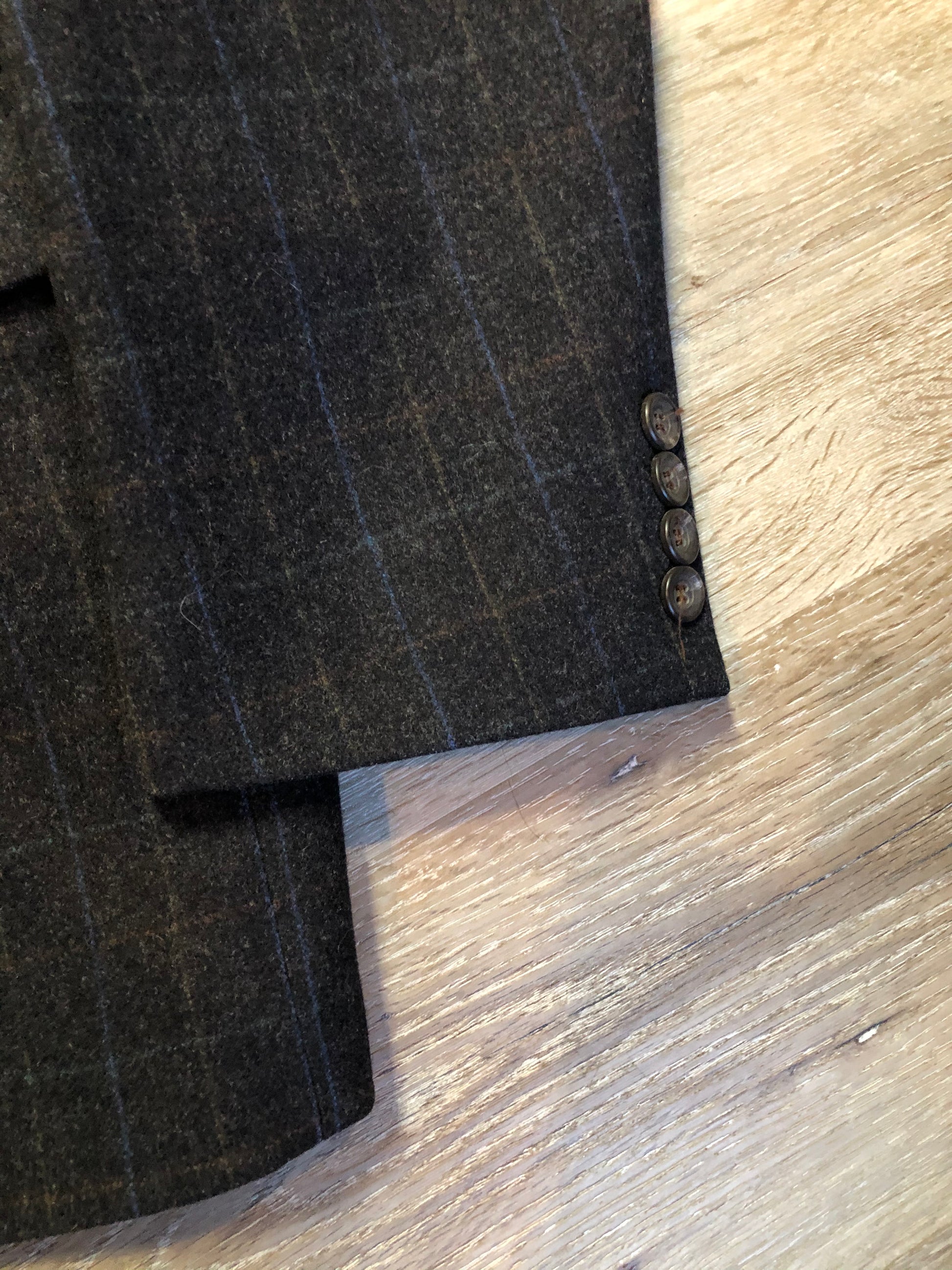 Kingspier Vintage - Chaps by Ralph Lauren slate grey with blue and red subtle stripe 100% wool jacket. This jacket is a two button, notch lapel with two flap pockets, a breast pocket and three inside pockets. Made in Canada.