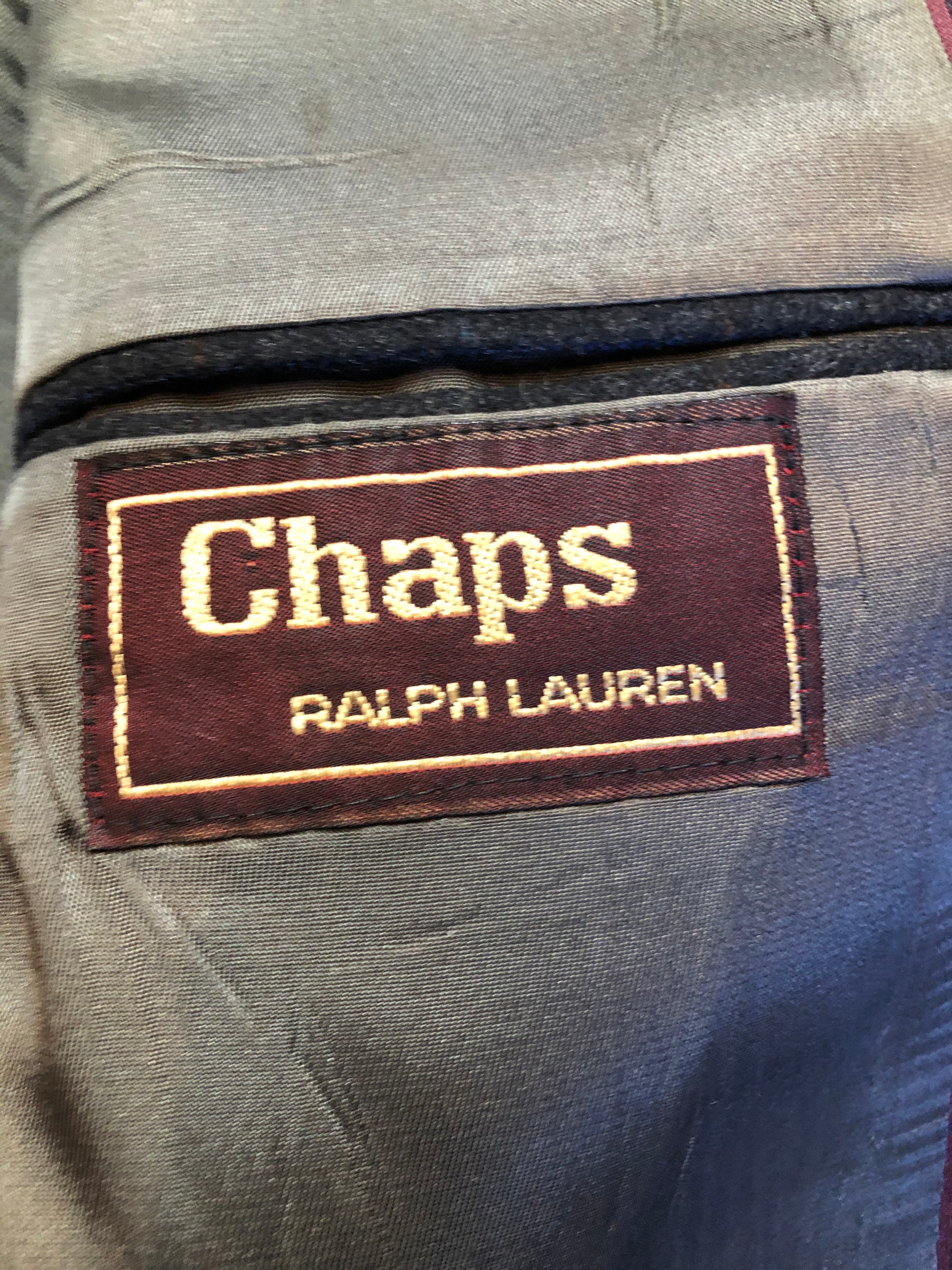 Kingspier Vintage - Chaps by Ralph Lauren slate grey with blue and red subtle stripe 100% wool jacket. This jacket is a two button, notch lapel with two flap pockets, a breast pocket and three inside pockets. Made in Canada.