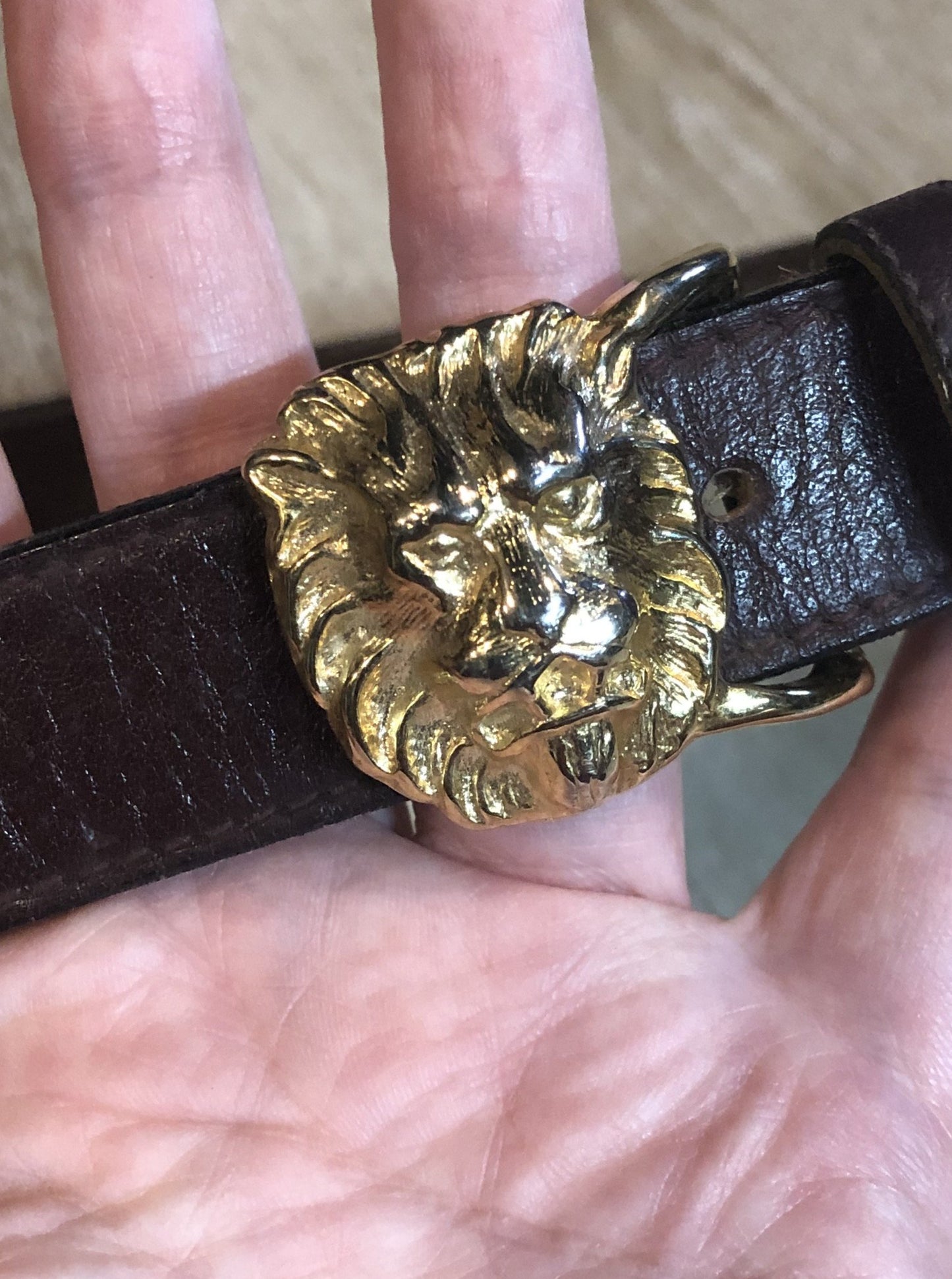 Kingspier Vintage - Vintage Ann Klein Caleche brown textured leather belt with gold lion’s head buckle.