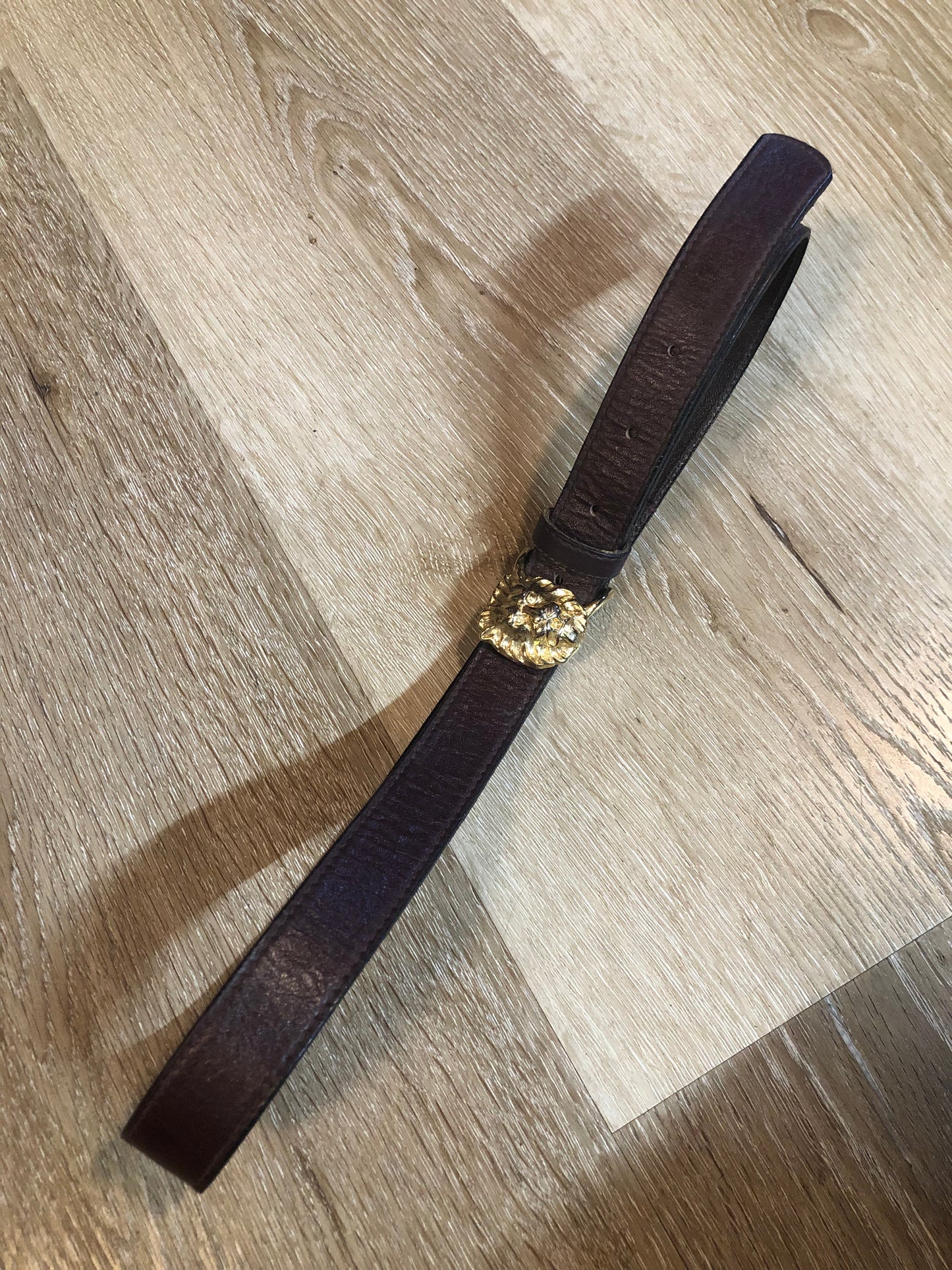 Kingspier Vintage - Vintage Ann Klein Caleche brown textured leather belt with gold lion’s head buckle.