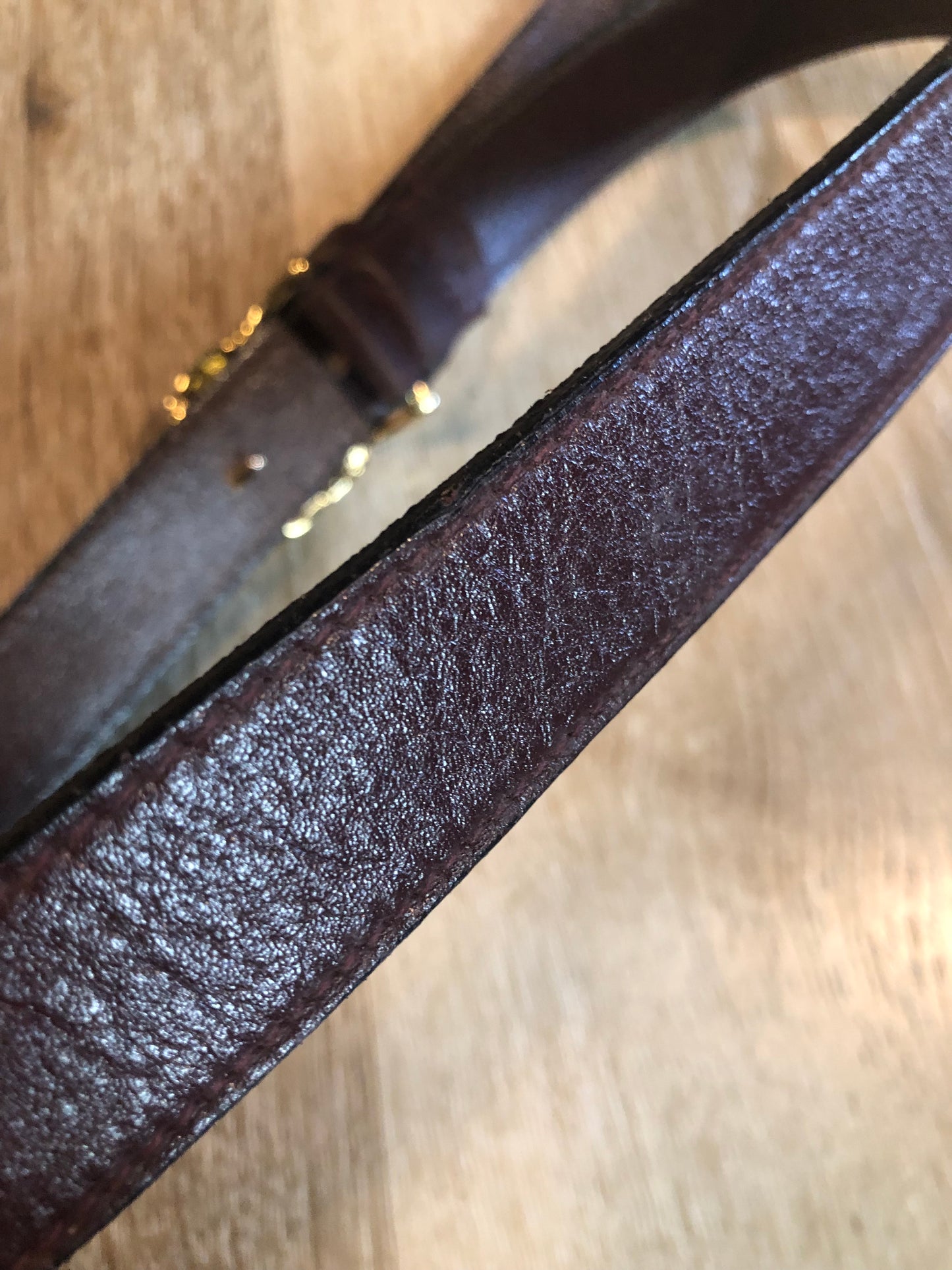 Kingspier Vintage - Vintage Ann Klein Caleche brown textured leather belt with gold lion’s head buckle.