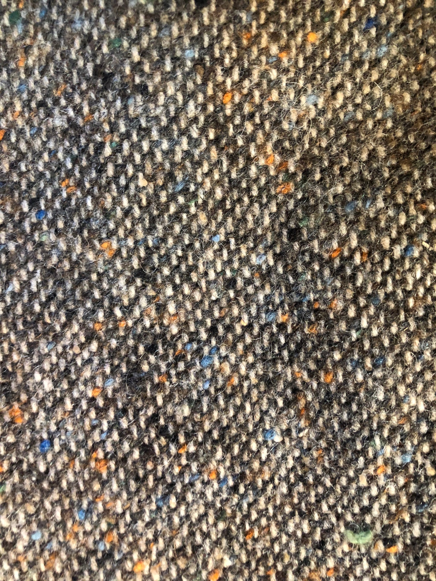 Kingspier Vintage - Donegal handwoven grey with blue and orange flecks 100% wool tweed jacket. This jacket is a two button, notch lapel with two patch pockets, a breast pocket and two inside pockets and a “this I defend” emblem embroidered on the chest. Made in Ireland.