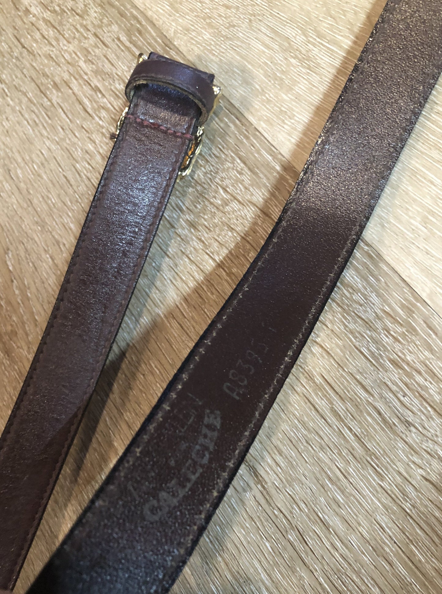 Kingspier Vintage - Vintage Ann Klein Caleche brown textured leather belt with gold lion’s head buckle.