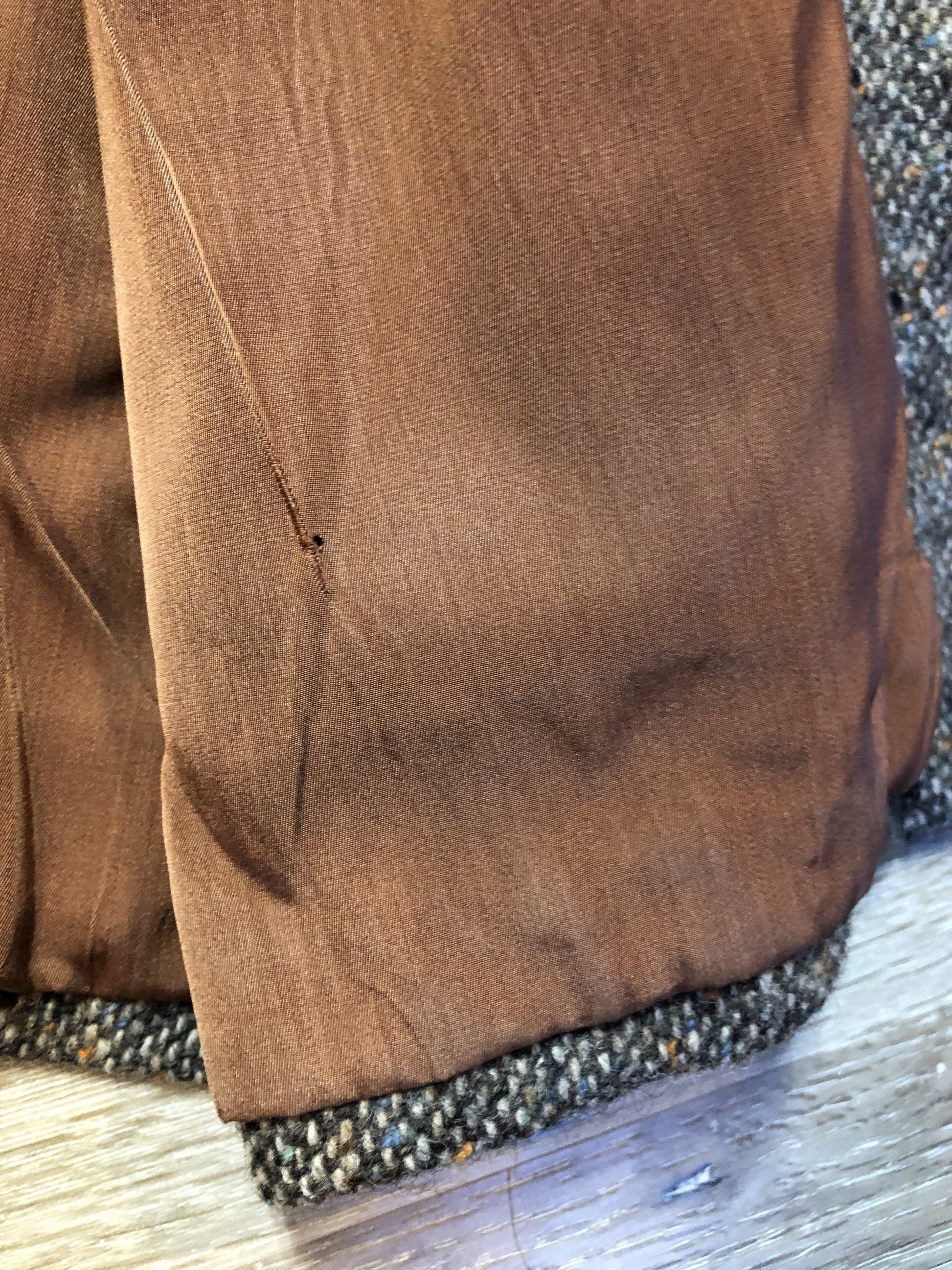 Kingspier Vintage - Donegal handwoven grey with blue and orange flecks 100% wool tweed jacket. This jacket is a two button, notch lapel with two patch pockets, a breast pocket and two inside pockets and a “this I defend” emblem embroidered on the chest. Made in Ireland.