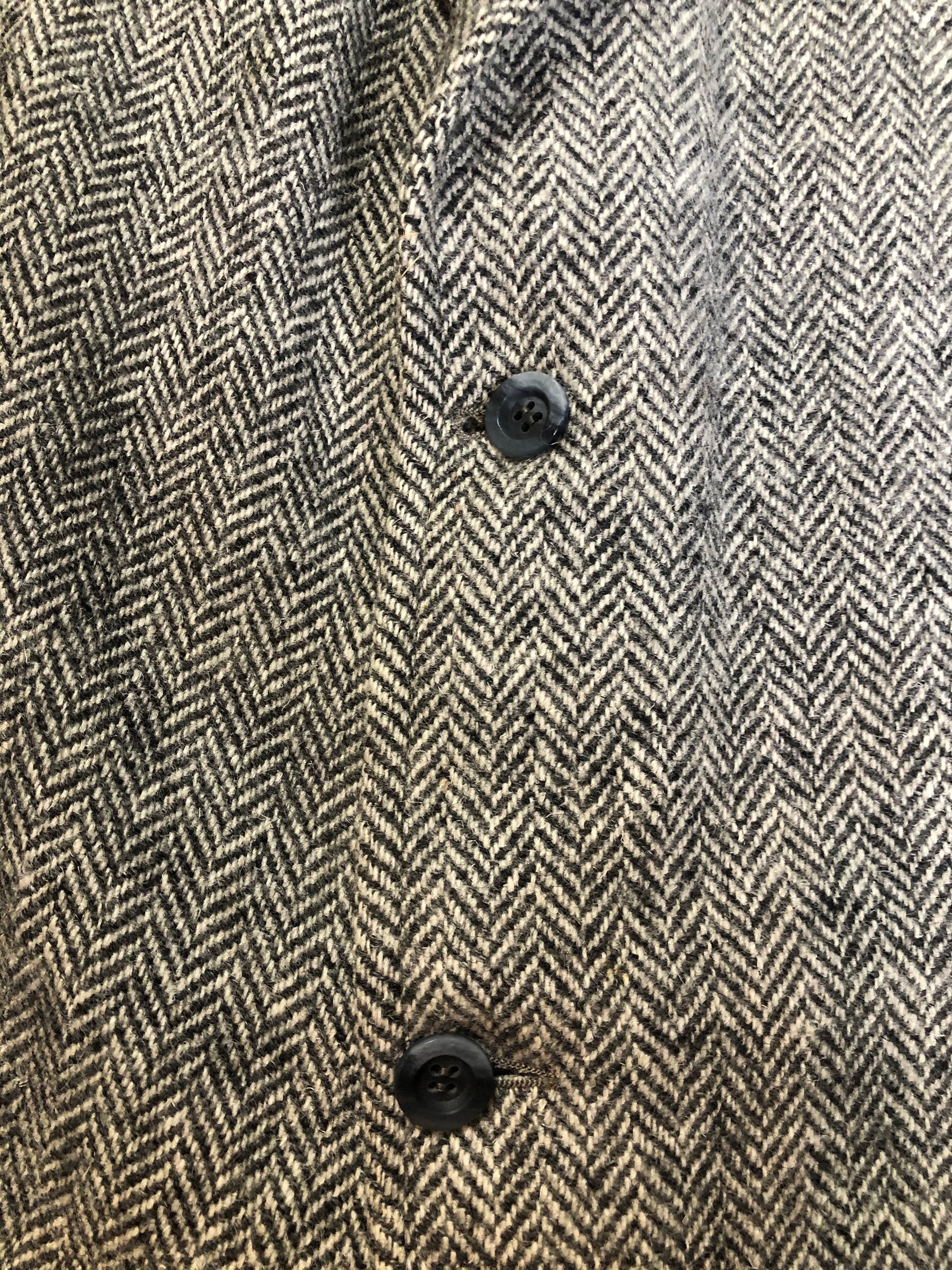 Kingspier Vintage - Morris Goldberg’s grey herringbone 100% wool tweed jacket. This jacket is a two button, notch lapel with two flap pockets, a breast pocket and three inside pockets. Made in Halifax, Nova Scotia.