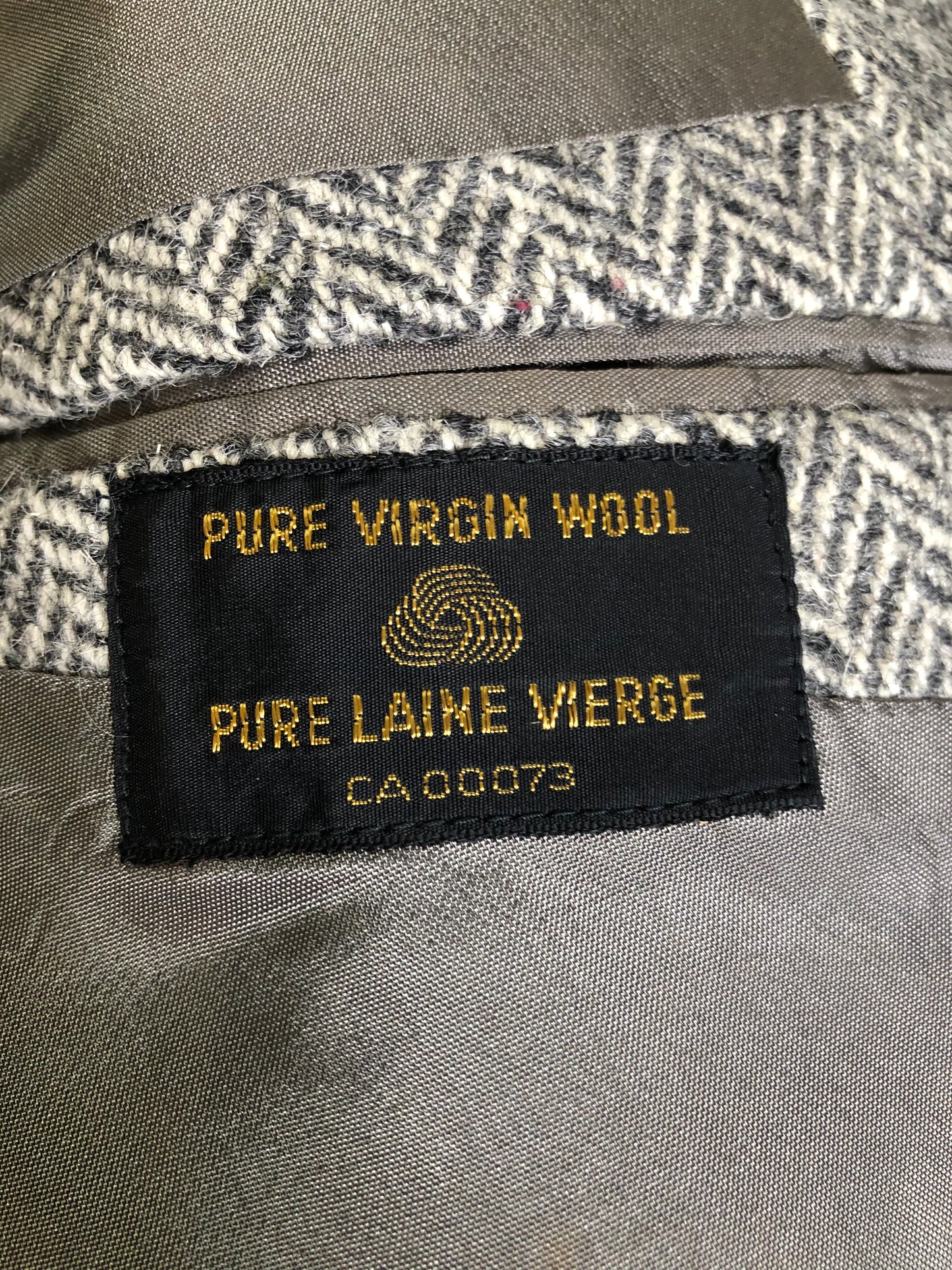 Kingspier Vintage - Morris Goldberg’s grey herringbone 100% wool tweed jacket. This jacket is a two button, notch lapel with two flap pockets, a breast pocket and three inside pockets. Made in Halifax, Nova Scotia.