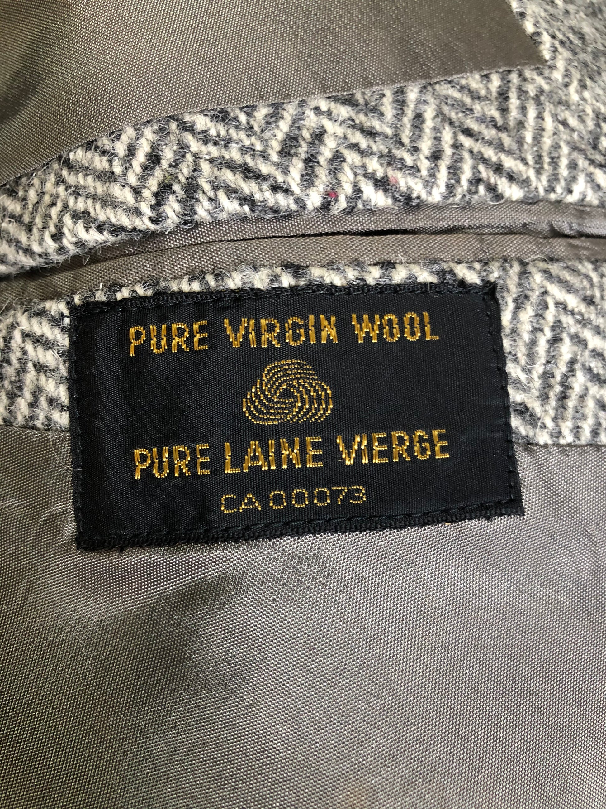 Kingspier Vintage - Morris Goldberg’s grey herringbone 100% wool tweed jacket. This jacket is a two button, notch lapel with two flap pockets, a breast pocket and three inside pockets. Made in Halifax, Nova Scotia.